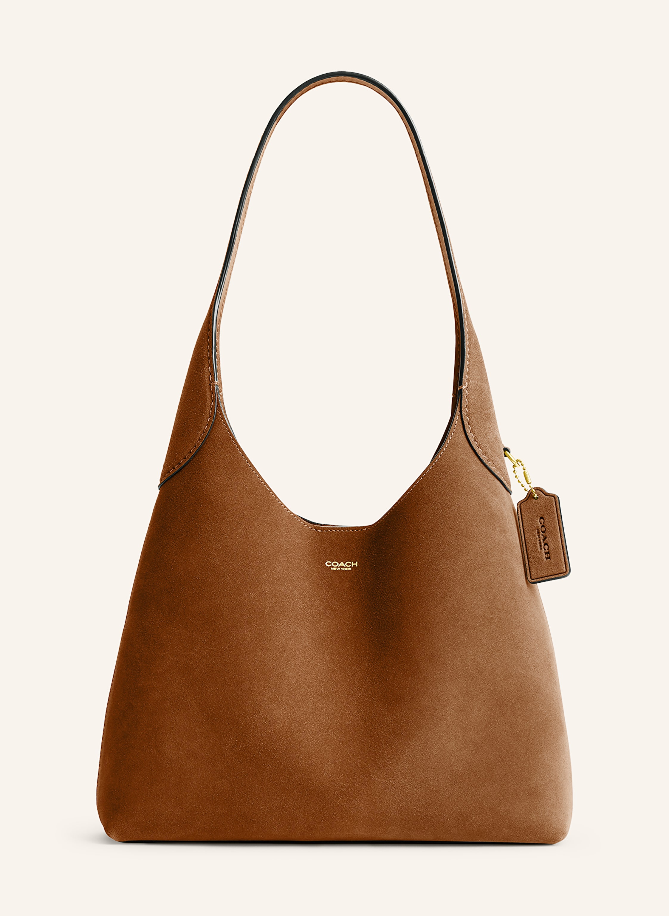 Coach Veloursleder. Schließt mit Magnetverschluss. Ein Tragegriff. Innen ein Hauptfach. Ein Steckfach. Verstärkter Taschenboden. Label-Emblem auf der Front in cognac
