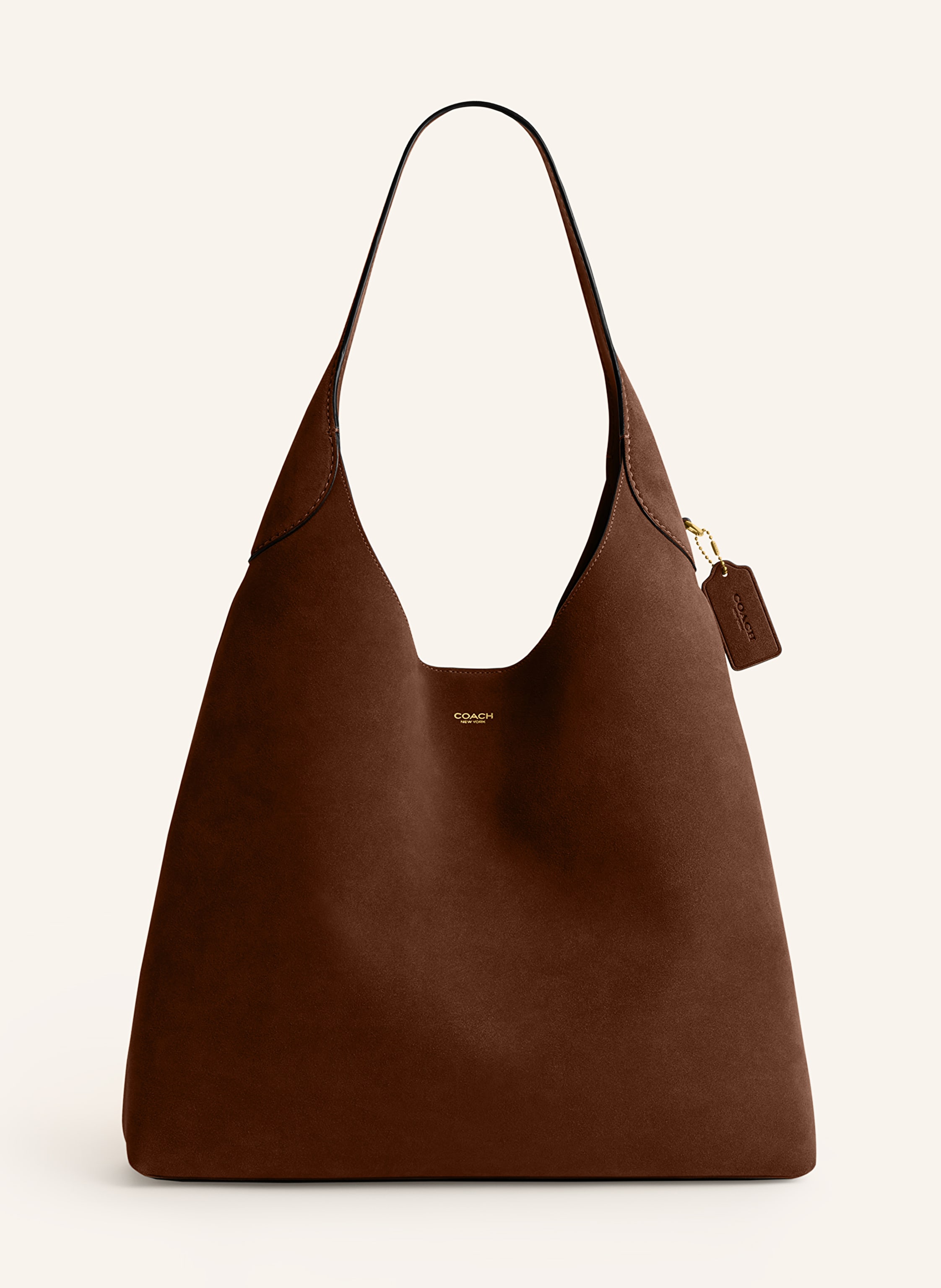 Coach Veloursleder. Schließt mit Druckknopf. Tragegriff. Innen ein Hauptfach. Innenfach mit Druckknopf. Verstärkter Taschenboden. Label-Schriftzug auf der Front. Label-Applikation hinten Large in cognac