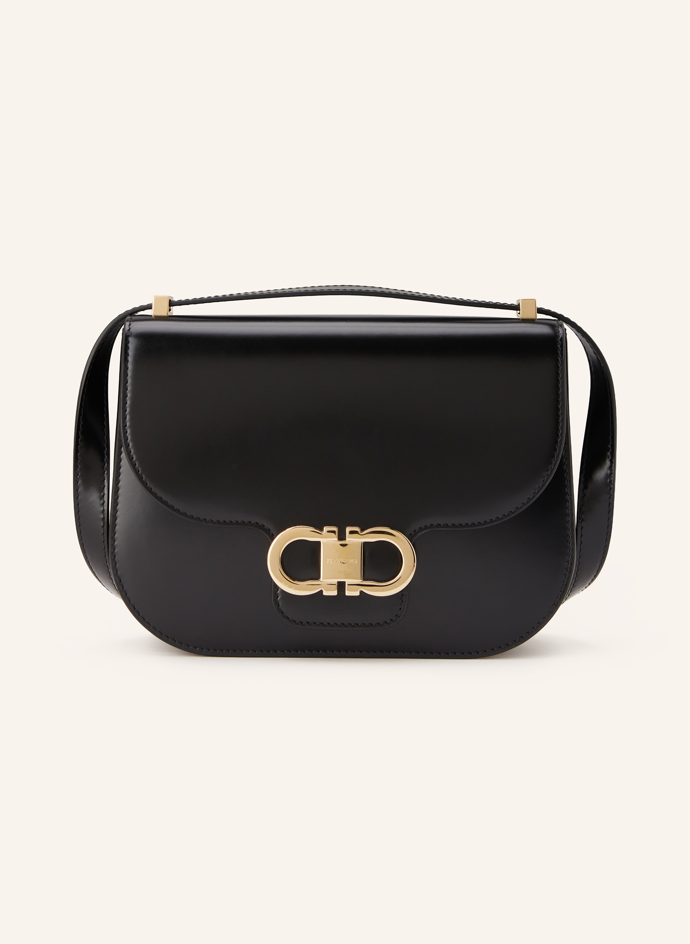 Ferragamo Außenfach auf der Rückseite. Ein Steckfach. Innen ein Hauptfach. Zwei Kartenfächer. Abnehmbarer Schulterriemen. Längenverstellbarer Schulterriemen. Magnetverschluss. Made in Italy. Label-Detail. Glatt in schwarz / gold