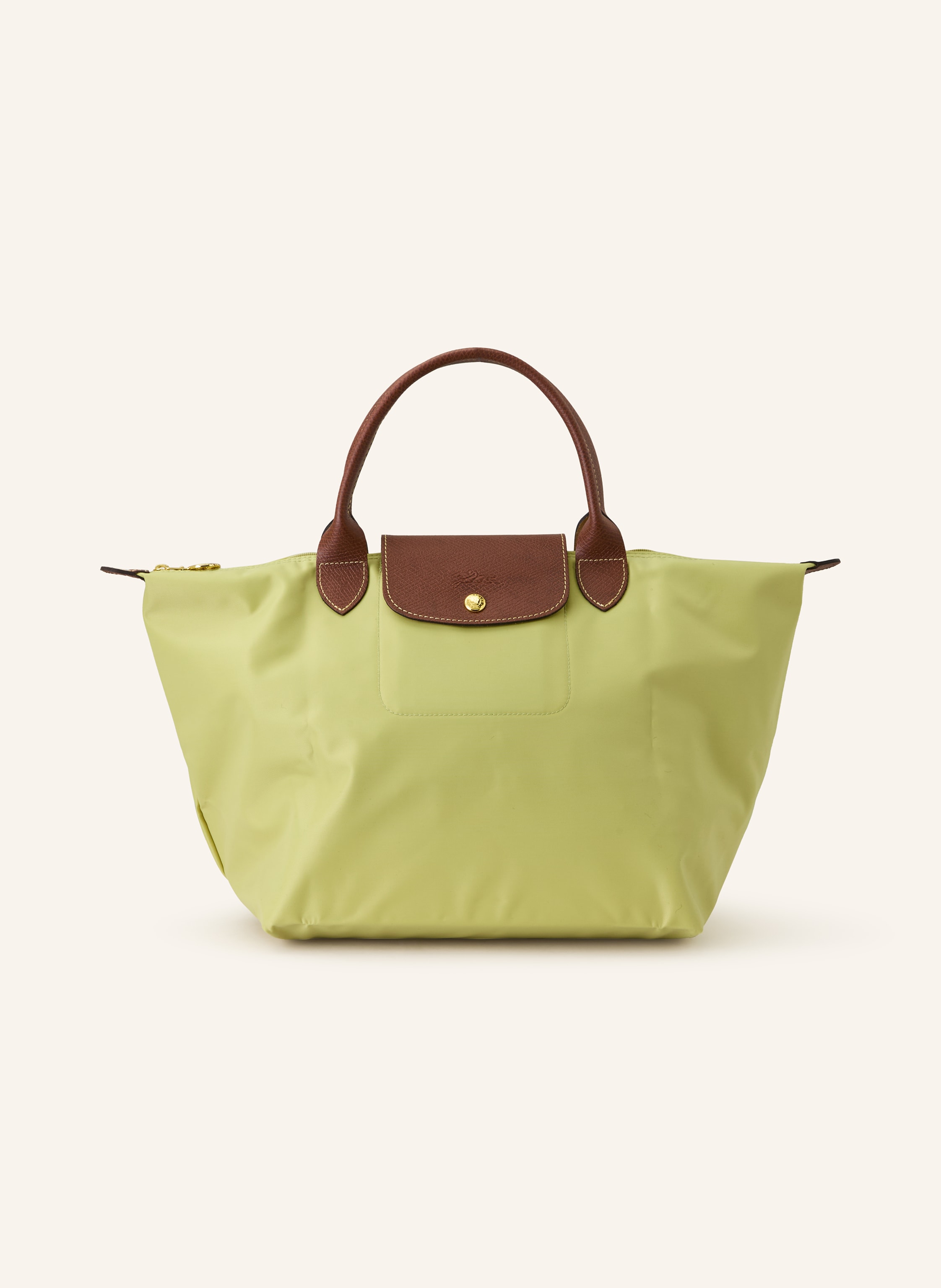 Longchamp Synthetik mit Lederdetails. Goldfarbene Metalldetails. Schließt mit einem Reißverschluss. Umschlag mit Druckknopf. Logo-Prägung. Faltbar in hellgrün / braun