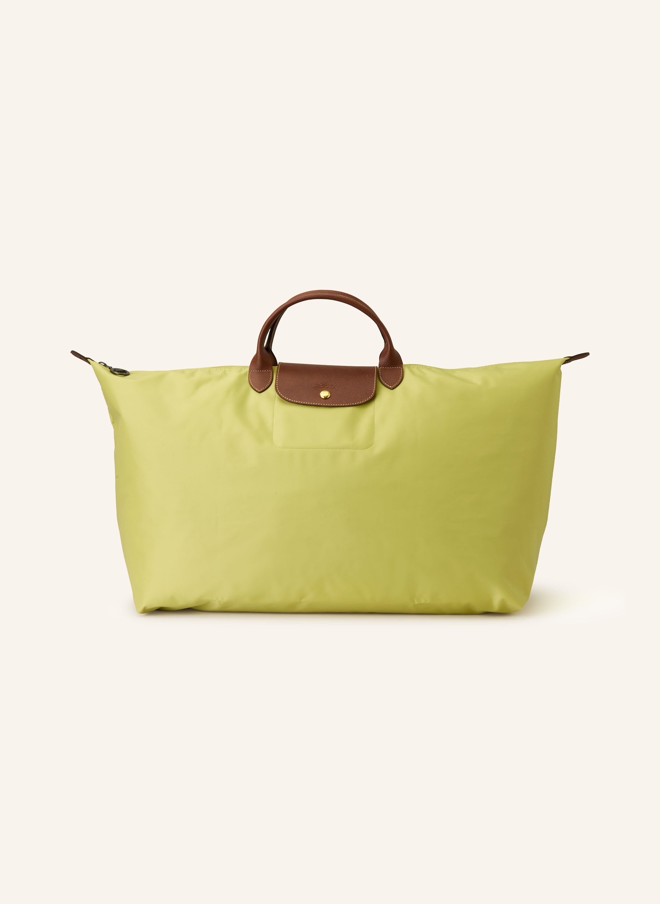 Longchamp Textil mit genarbten Lederdetails. Schließt mit Reißverschluss und Druckknopf. Tragegriffe. Innen ein Hauptfach. Steckfach für Smartphone & Co. Label-Emblem auf der Front. Faltbar in hellgrün / braun