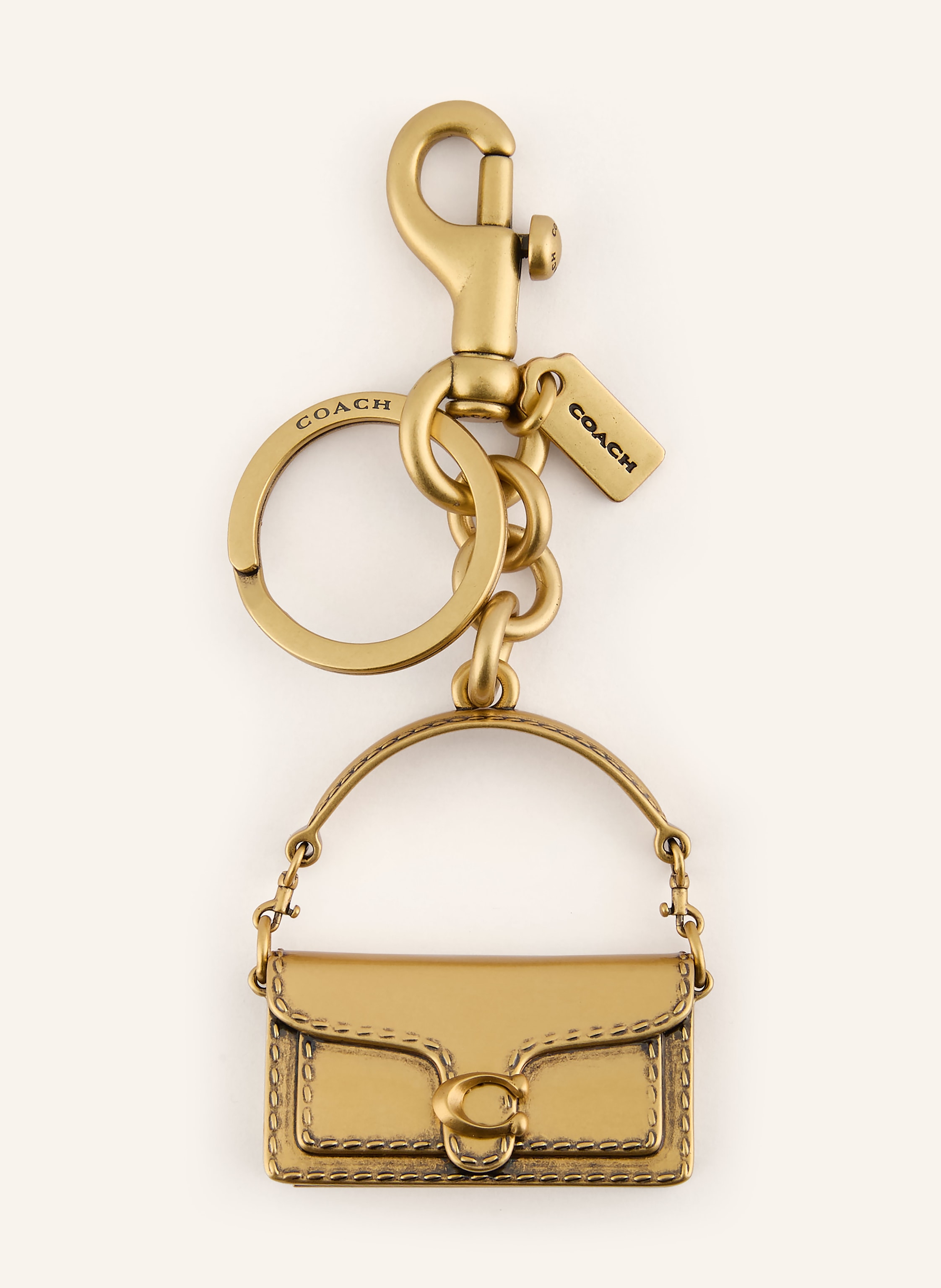 Coach Karabiner. Label-Anhänger. Unifarben in gold