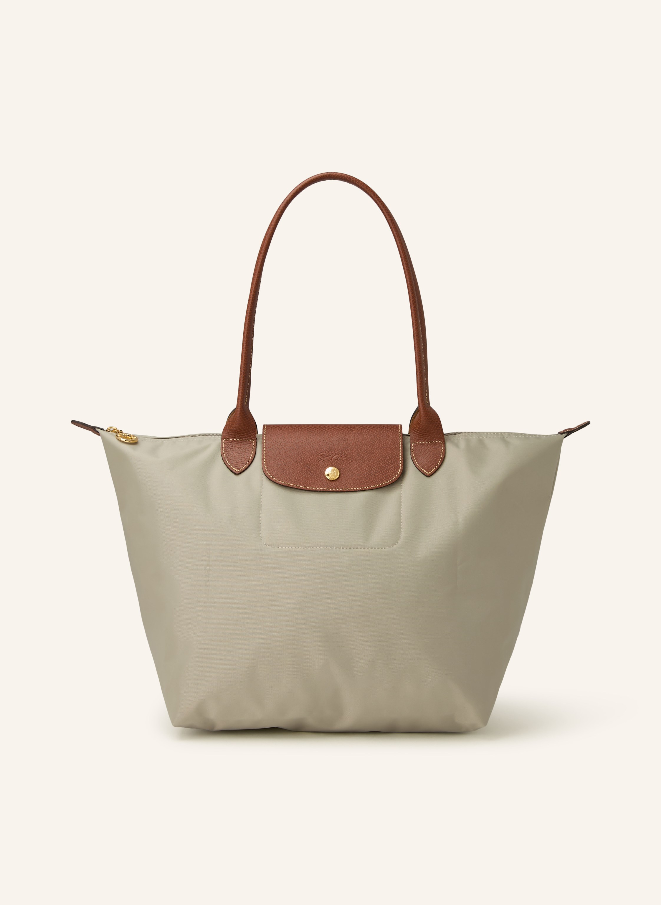 Longchamp Nylon und Leder. Tragehenkel. Schließt mit Reißverschluss. Lederbesatz mit Druckknopf und Logo-Prägung. Faltbar. Innentasche in taupe / braun