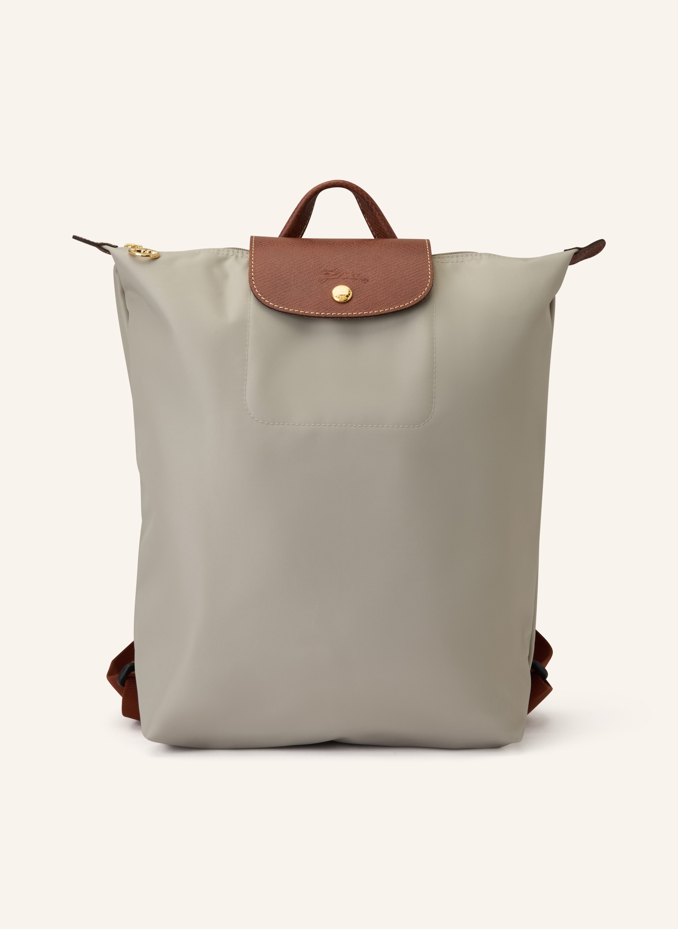 Longchamp Synthetische Verarbeitung mit Lederdetails. Goldfarbene Metalldetails. Schließt mit einem Reißverschluss und Druckknopf. Längenverstellbarer Schulterriemen. Handgriff. Logo-Prägung am Überschlag. Dank Medium in grau / braun