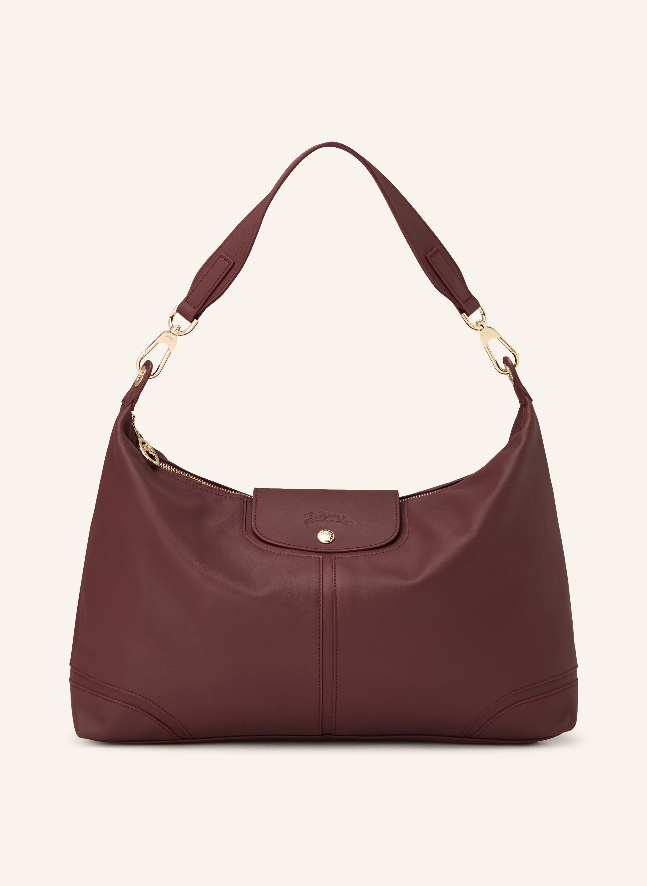 Longchamp Ein Innenfach mit Reißverschluss. Ein Steckfach. Abnehmbarer Schulterriemen. Druckknopf. Reißverschluss. Innen ein Hauptfach. Label-Anhänger. Fein genarbtes Leder. Unifarben in dunkelrot / gold