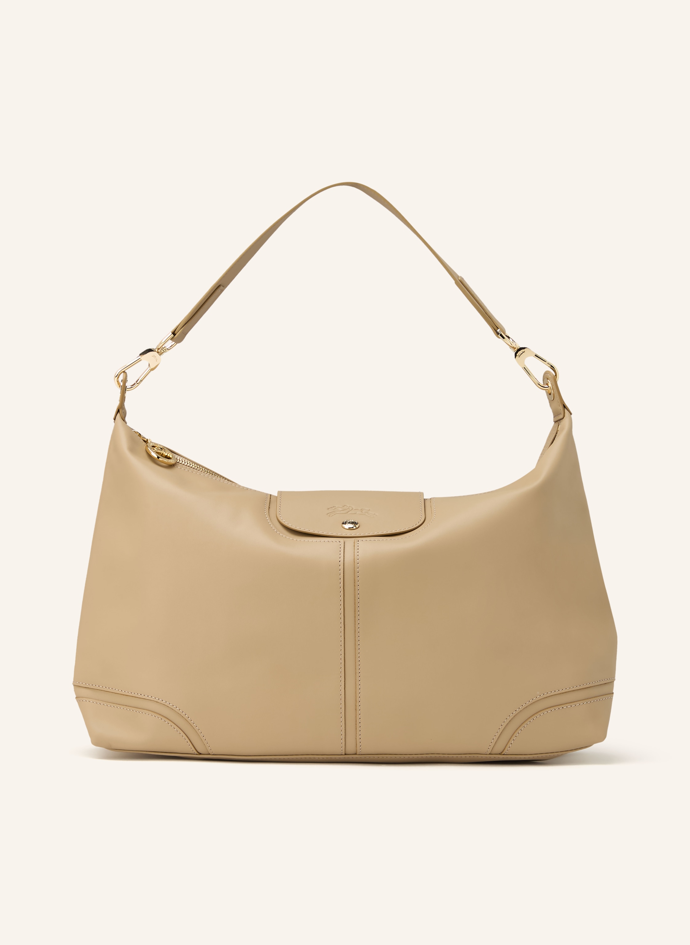Longchamp Ein Innenfach mit Reißverschluss. Ein Steckfach. Abnehmbarer Schulterriemen. Druckknopf. Reißverschluss. Innen ein Hauptfach. Label-Anhänger. Fein genarbtes Leder. Unifarben in beige / gold