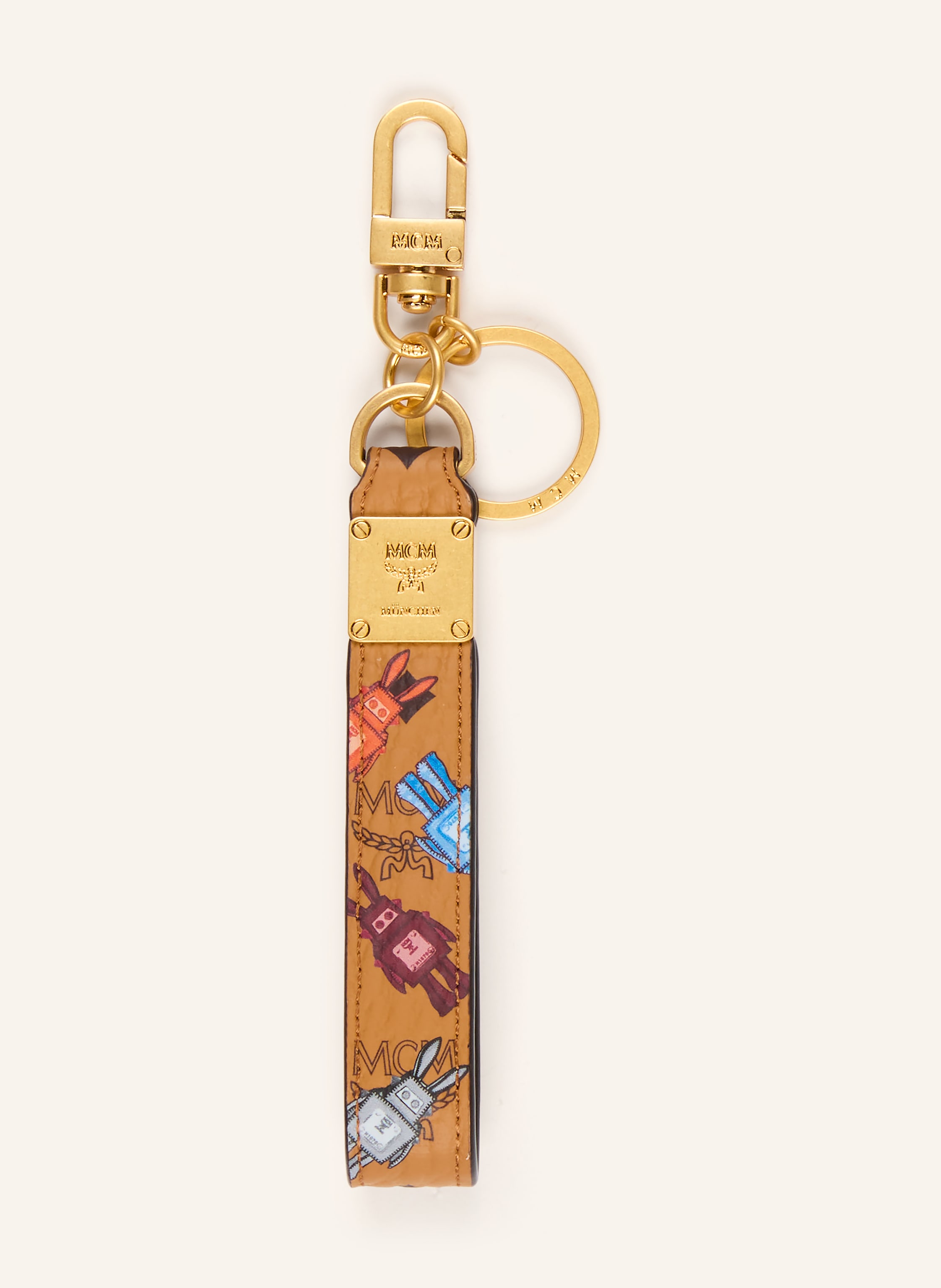 MCM Karabiner. Schlüsselring. Label-Print. Genarbtes Leder. Messing. Monogramm-Muster. 24-karätig vergoldete Hardware in cognac / gold