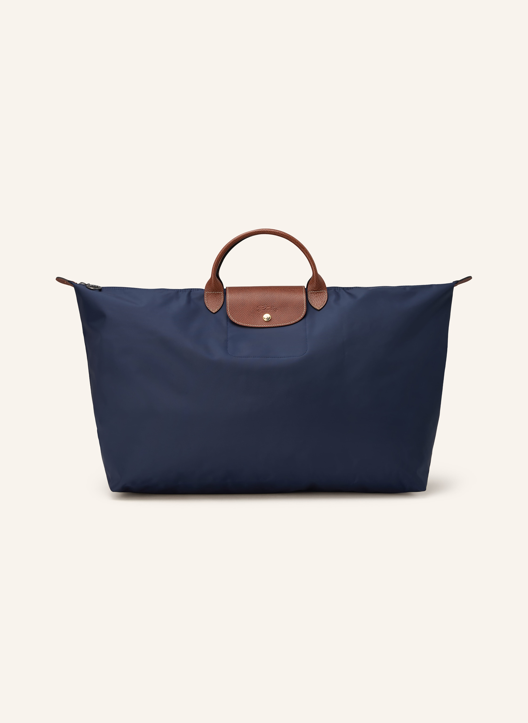 Longchamp Textil mit genarbten Lederdetails. Schließt mit Reißverschluss und Druckknopf. Tragegriffe. Innen ein Hauptfach. Steckfach für Smartphone & Co. Label-Emblem auf der Front. Faltbar in dunkelblau / gold / braun