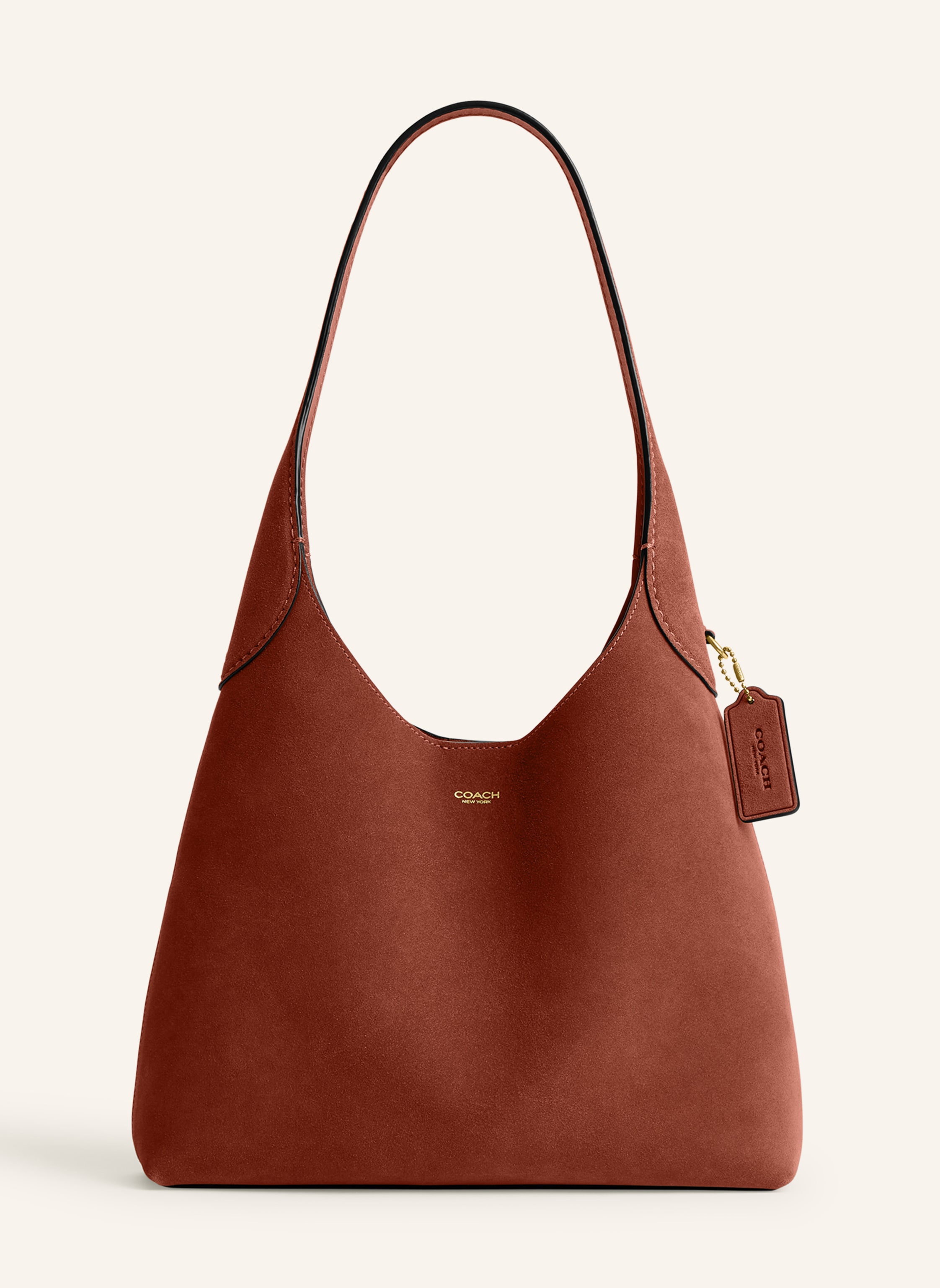 Coach Veloursleder. Schließt mit Magnetverschluss. Ein Tragegriff. Innen ein Hauptfach. Ein Steckfach. Verstärkter Taschenboden. Label-Emblem auf der Front in braun / gold