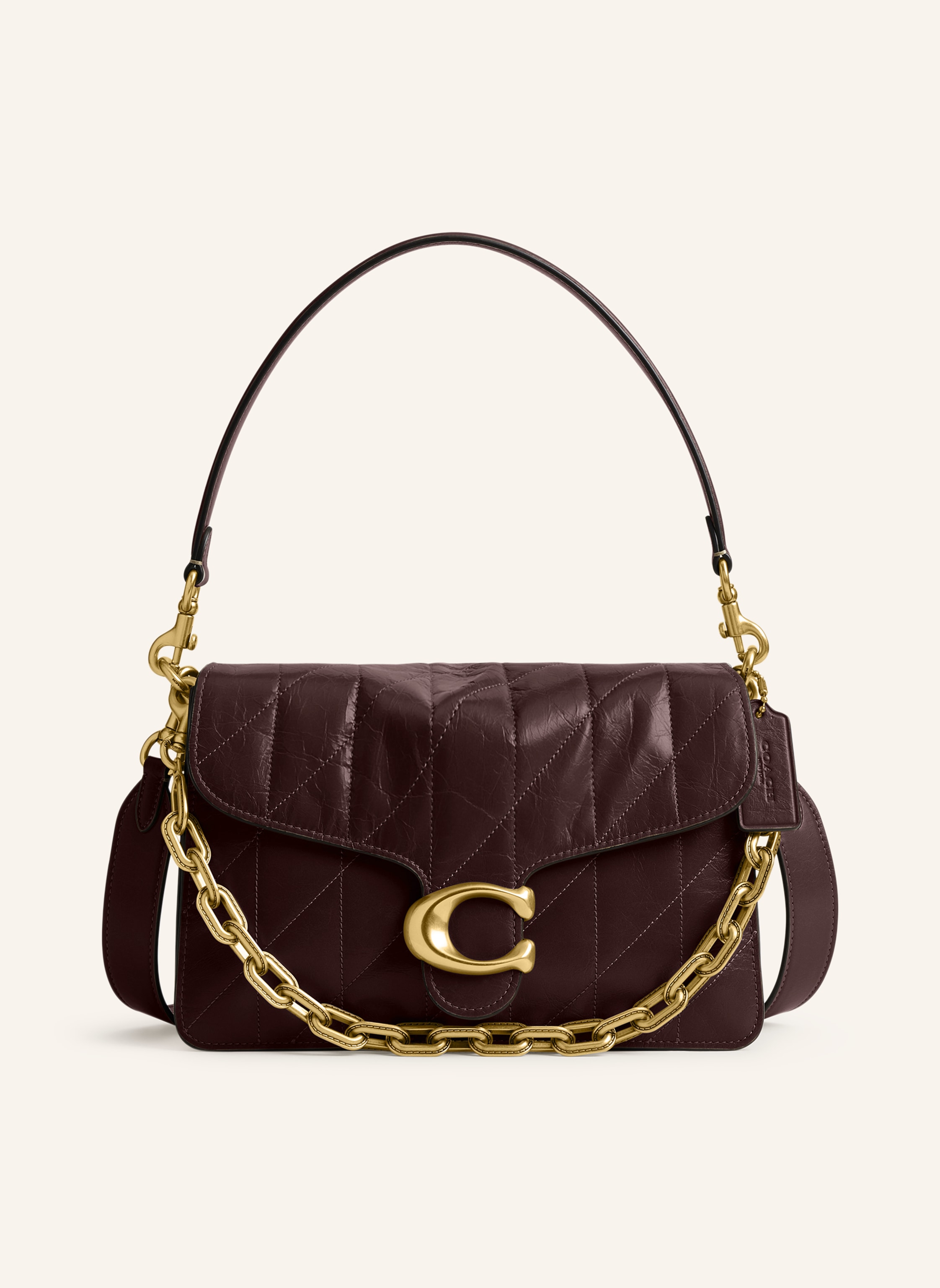 Coach Genarbtes Leder. Leder in Crinkle-Optik. Gestepptes Design. Schließt mit magnetischem Druckknopf. Abnehmbarer Schulterriemen. Zusätzlicher abnehmbarer, längenverstellbarer Schulterriemen. Außenfach au in dunkelbraun / gold