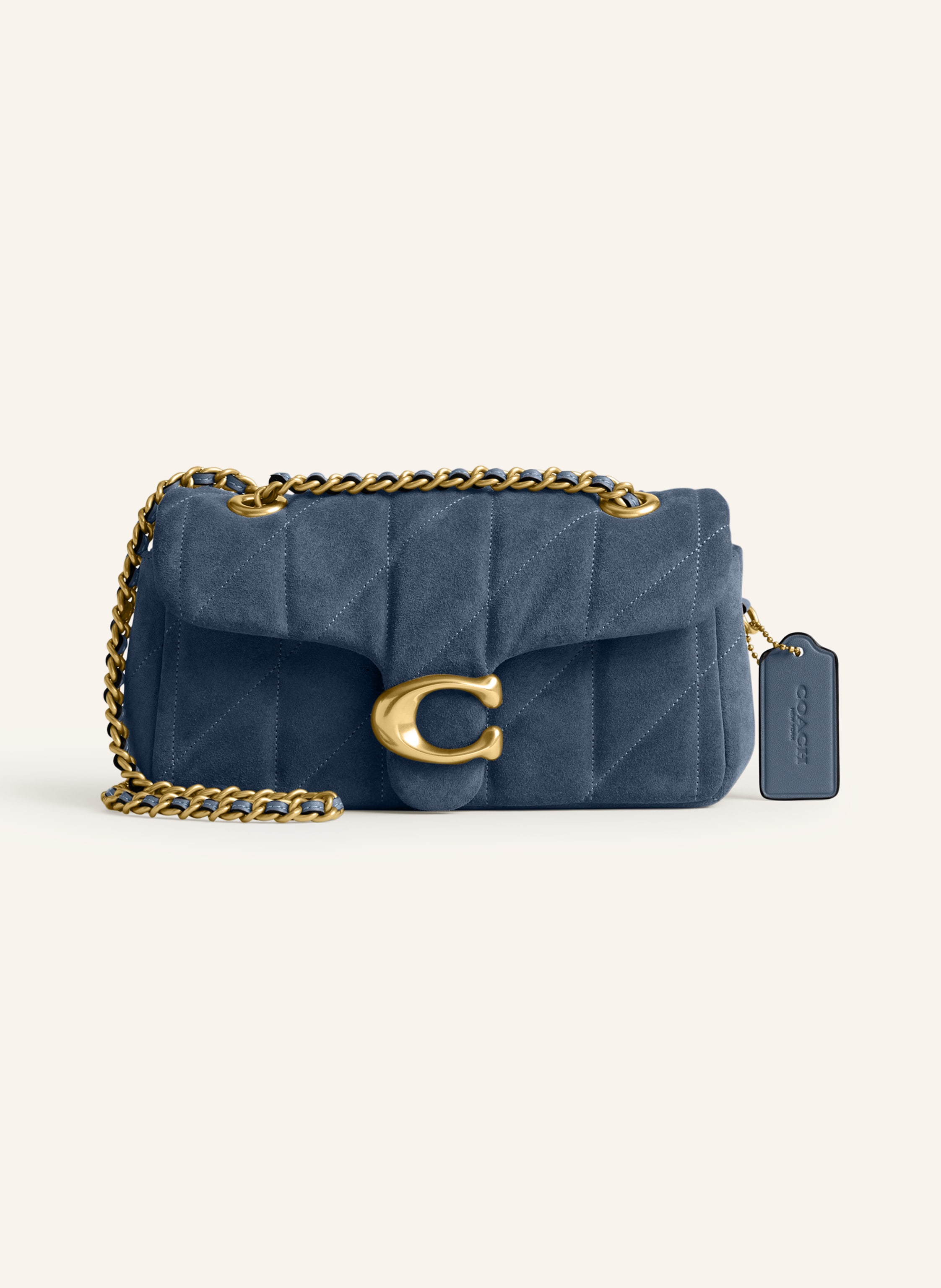 Coach Veloursleder. Gestepptes Design. Schließt mit Logo-Verschluss. Schulterkette kann einzeln oder doppelt getragen werden. Außenfach auf der Rückseite. Außenfach unter Überschlag. Innen zwei Hauptfächer. in dunkelblau