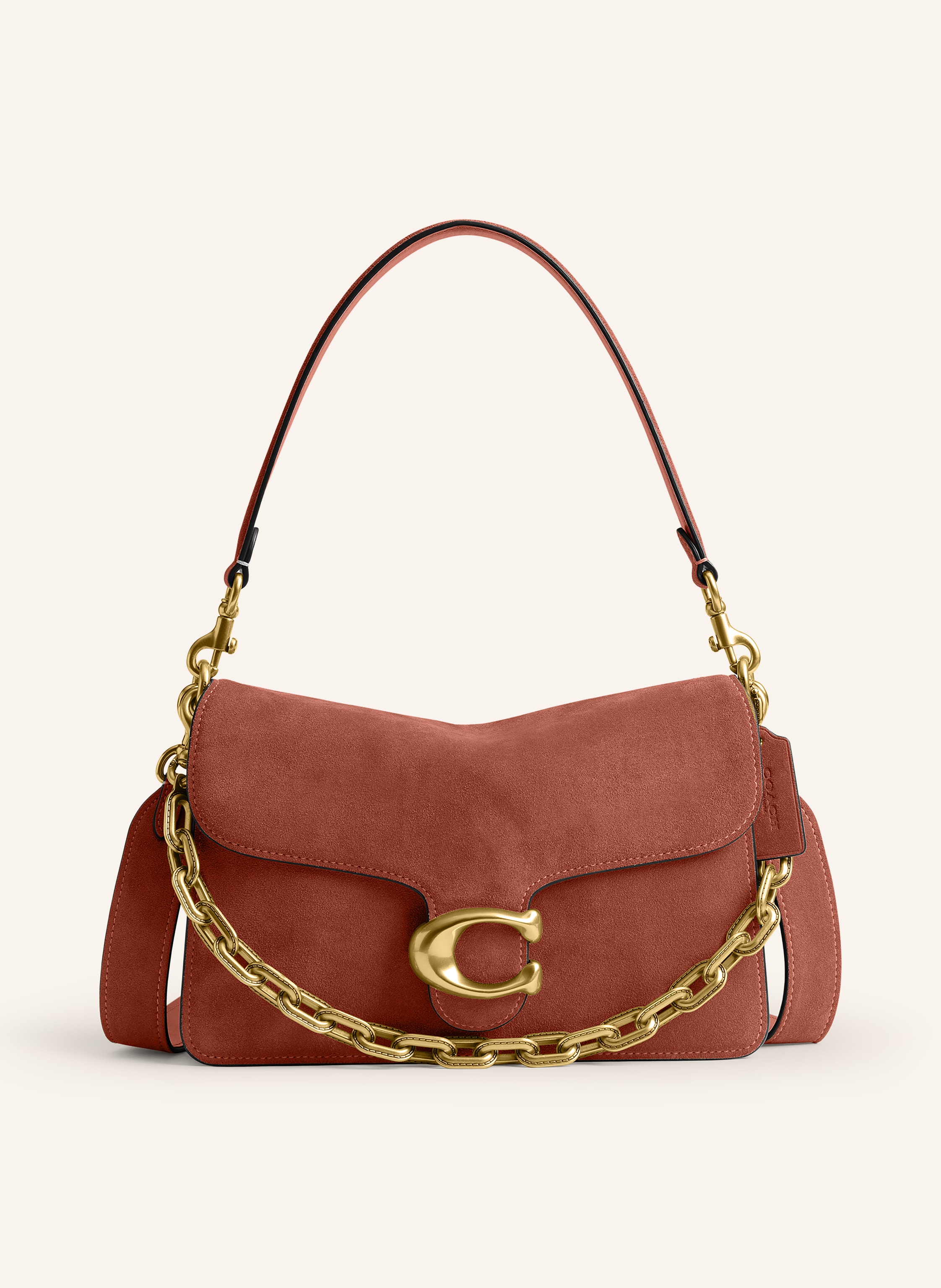 Coach Außenfach mit Reißverschluss. Abnehmbarer Schulterriemen. Ein Tragegriff. Schulterkette. Stellfüßchen. Verstärkter Taschenboden. Druckknopf. Innen zwei Hauptfächer. Label-Detail. Aus Veloursleder. Uni in braun / gold