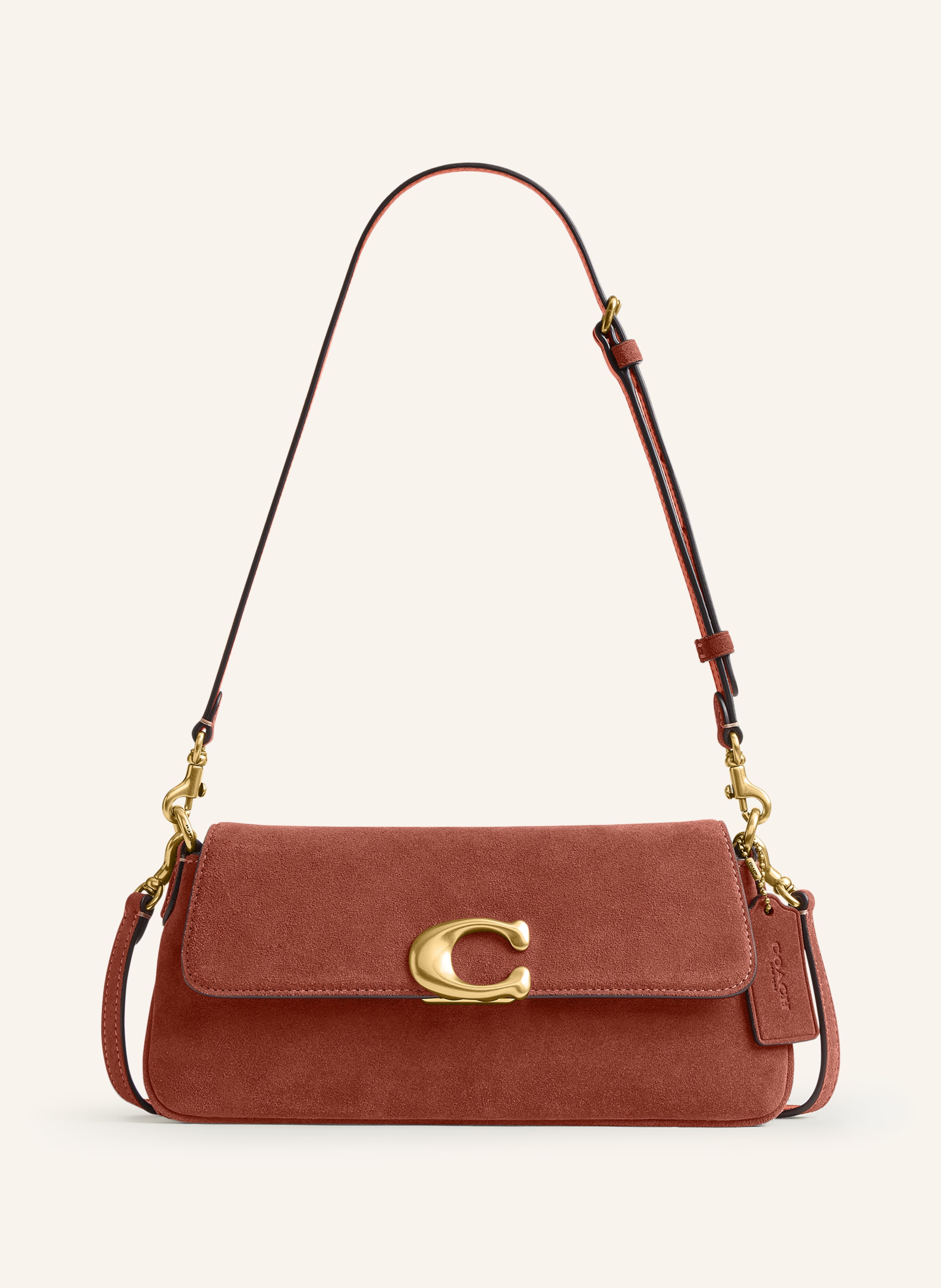 Coach Außenfach auf der Rückseite. Abnehmbarer Schulterriemen. Ein Tragegriff. Stellfüßchen. Verstärkter Taschenboden. Druckknopf. Innen zwei Hauptfächer. Label-Detail. Aus Veloursleder. Unifarben in braun / gold