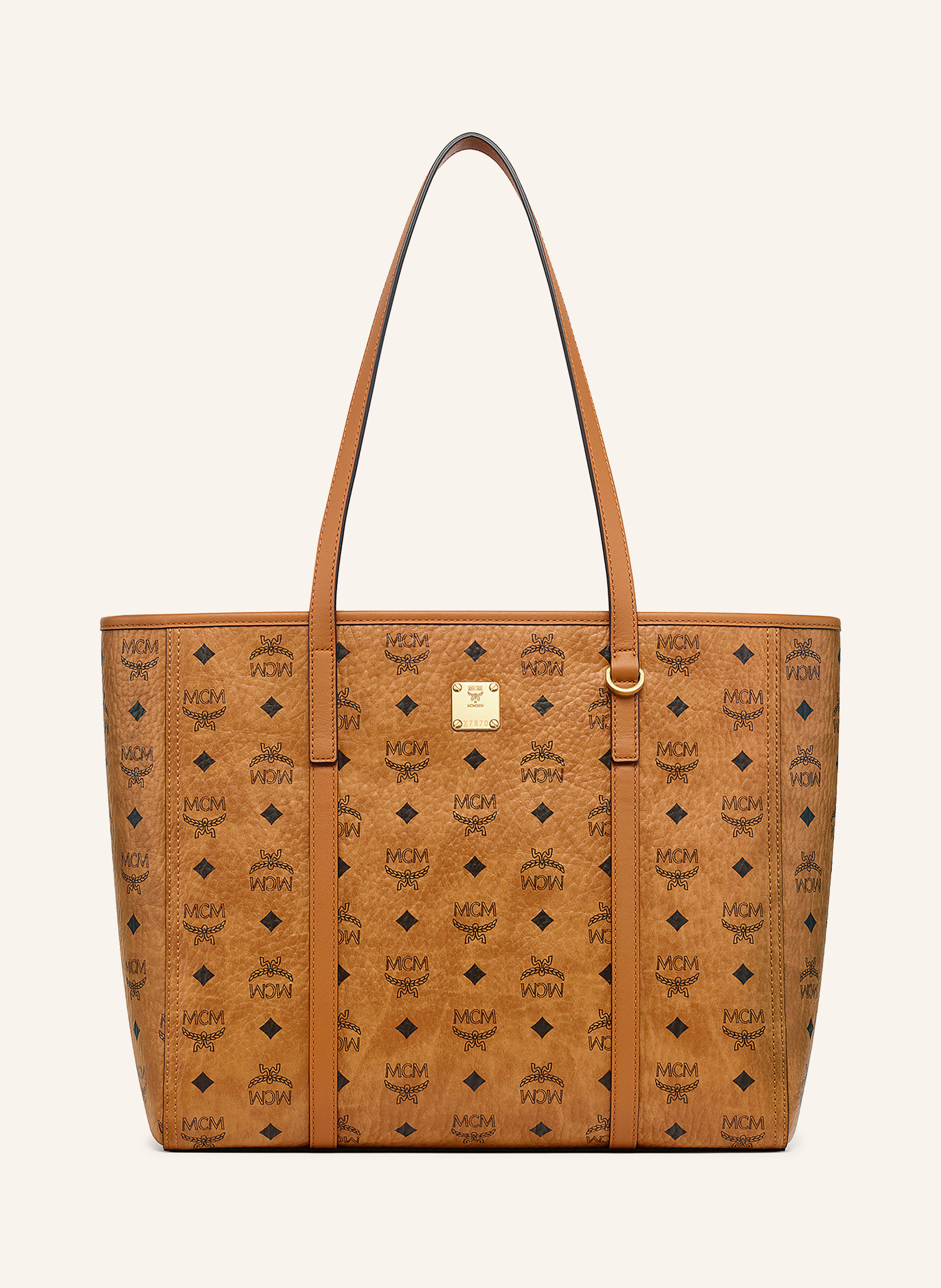 MCM Zwei Steckfächer. Zwei Tragegriffe. Verstärkter Taschenboden. Reißverschluss. Innen ein Hauptfach. Label-Detail. Monogramm-Muster. Genarbtes Leder. Made in Italy Medium in cognac / schwarz
