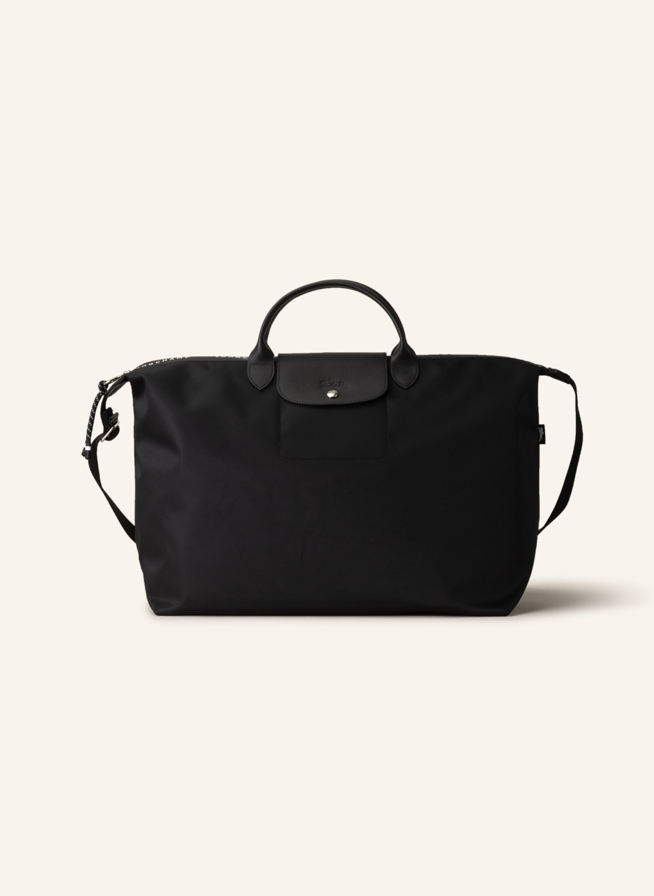 Longchamp Textil mit Lederdetails. Schließt mit Reißverschluss und Druckknopf. Längenverstellbarer Schulterriemen. Innen ein Hauptfach. Steckfach für Smartphone & Co. Label-Wording auf dem Reißverschluss. Logo- in schwarz