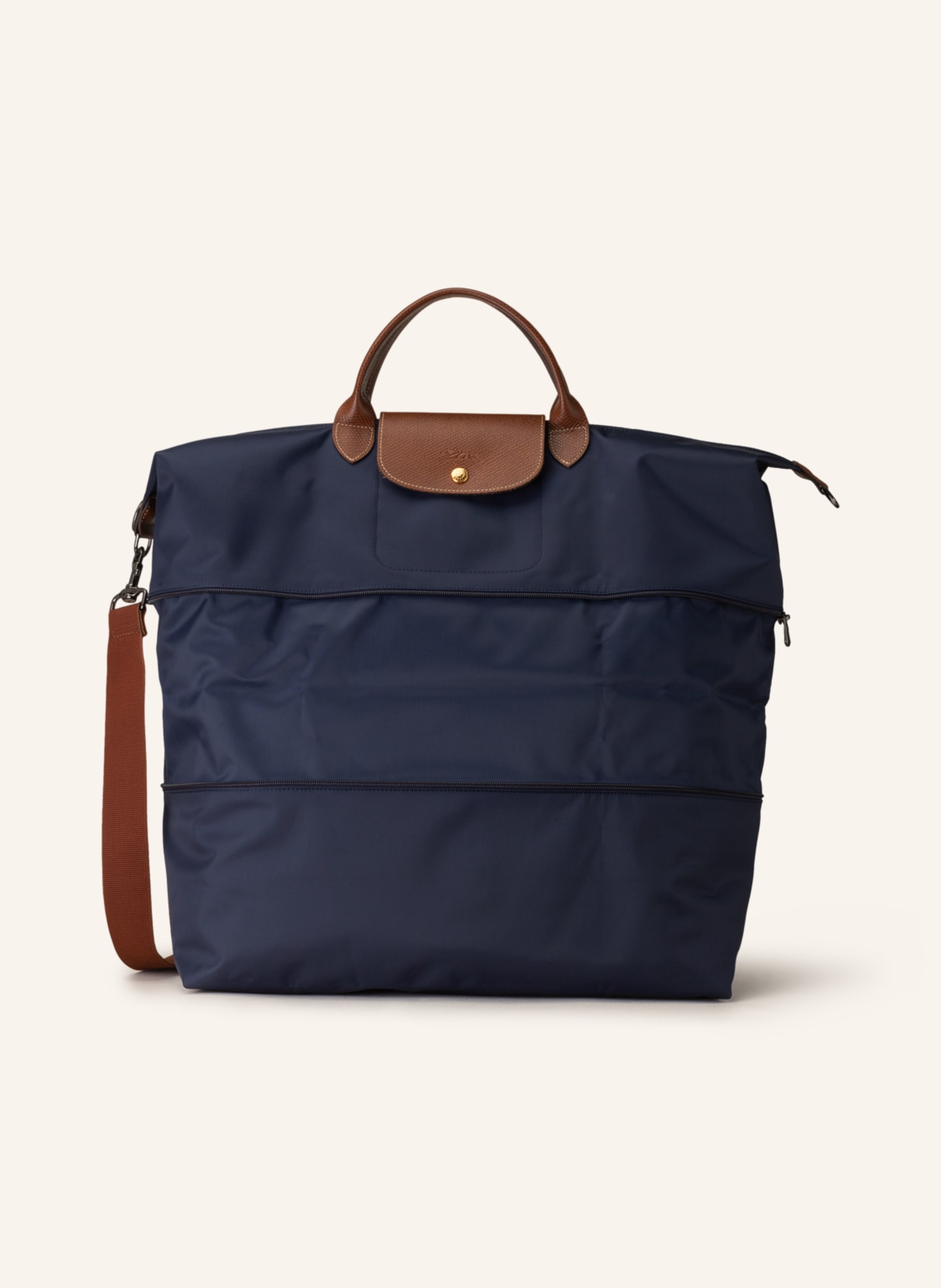 Longchamp Aus Textil und Leder. Schließt mit Druckknopf und Reißverschluss. Abnehmbarer, längenverstellbarer Schulterriemen. Außenfach auf Vorder- und Rückseite. Steckfach für Smartphone & Co. Erweiterbares Vol in dunkelblau