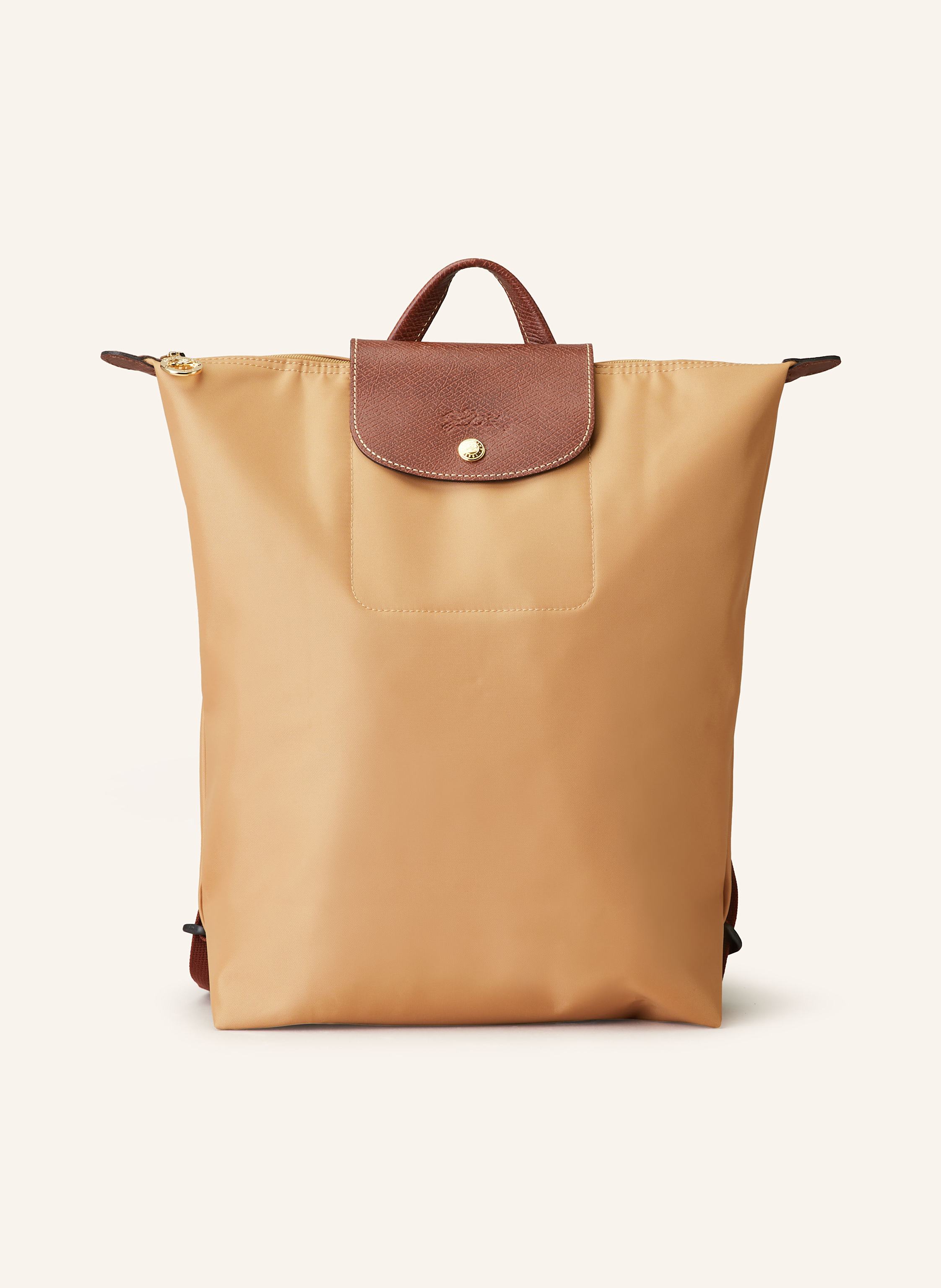 Longchamp Synthetische Verarbeitung mit Lederdetails. Goldfarbene Metalldetails. Schließt mit einem Reißverschluss und Druckknopf. Längenverstellbarer Schulterriemen. Handgriff. Logo-Prägung am Überschlag. Dank Medium in cognac / braun
