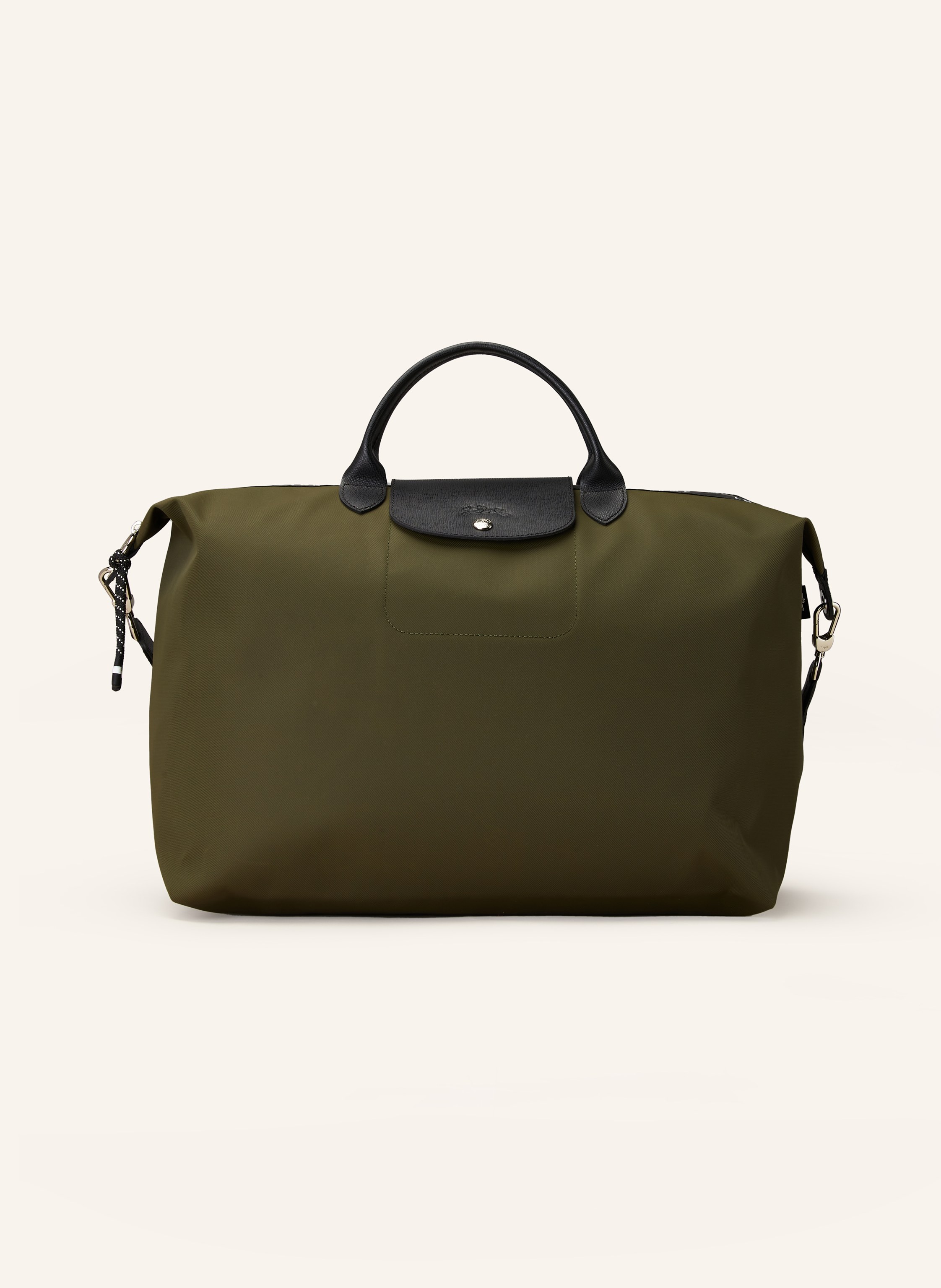 Longchamp Textil mit Lederdetails. Schließt mit Reißverschluss und Druckknopf. Längenverstellbarer Schulterriemen. Innen ein Hauptfach. Steckfach für Smartphone & Co. Label-Wording auf dem Reißverschluss. Logo- in khaki