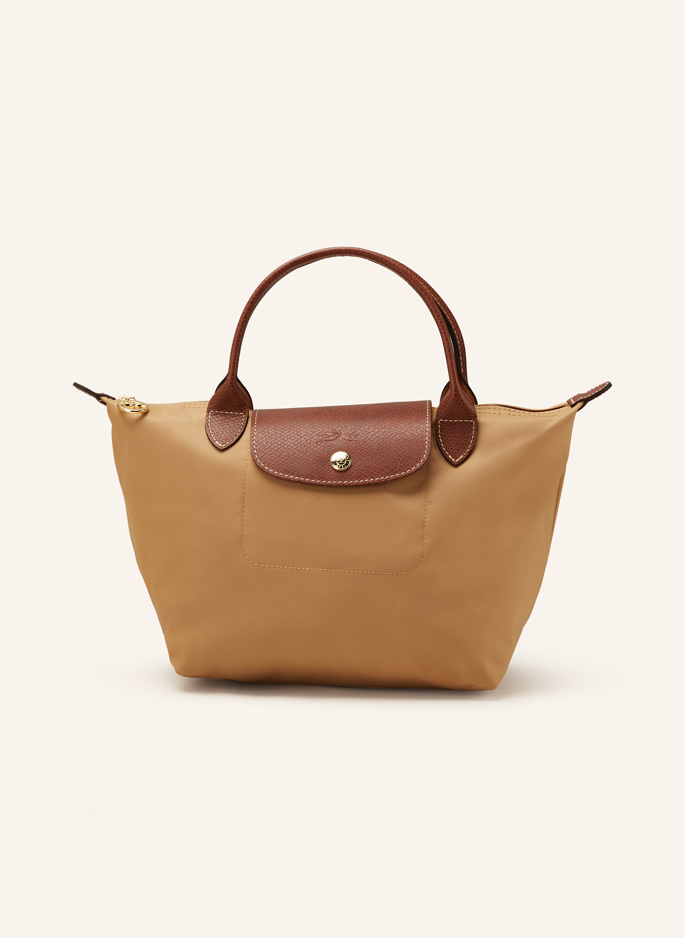 Longchamp Synthetik mit Lederdetails. Kurze Tragehenkel. Goldfarbene Metalldetails. Schließt mit einem Reißverschluss und Druckknopf. Faltbar in camel / cognac