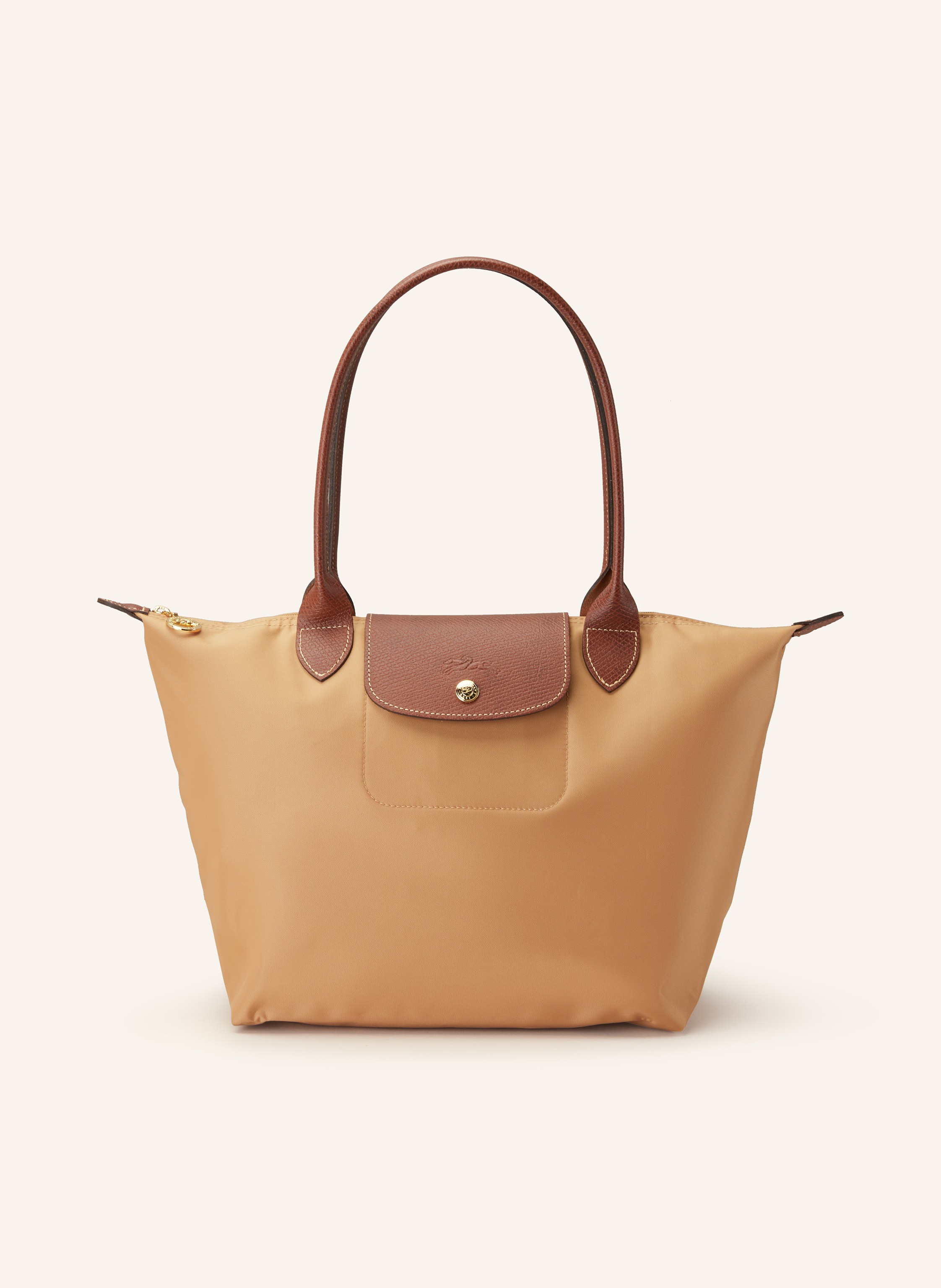 Longchamp Zwei Steckfächer. Zwei Tragegriffe. Druckknopf. Reißverschluss. Innen ein Hauptfach. Label-Detail. Genarbtes Leder. Textil. Bicolor-Design in cognac / braun