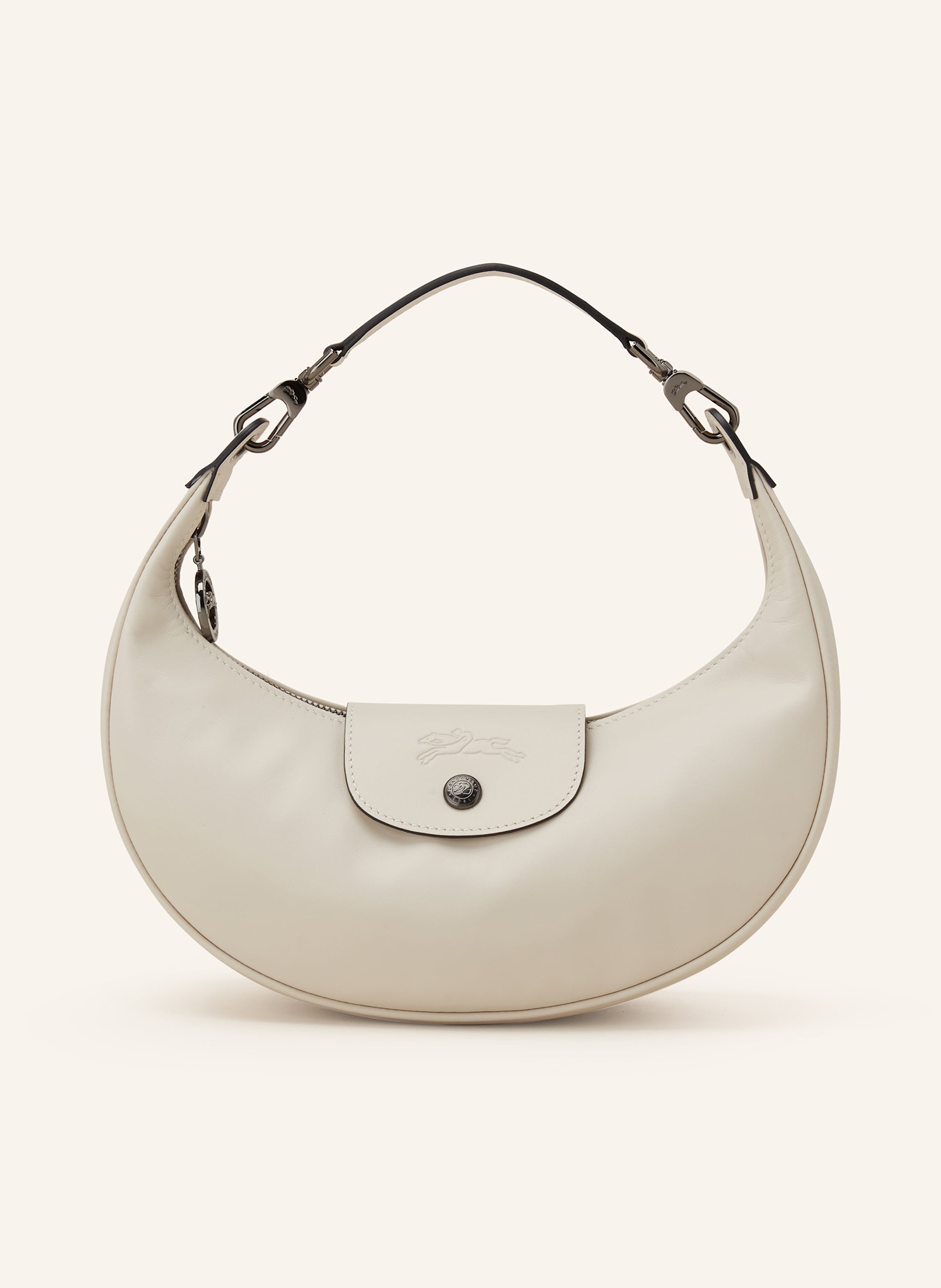 Longchamp Glattleder. Schließt mit Reißverschluss und Druckknopf. Ein Tragegriff. Innen ein Hauptfach. Innenfach mit Reißverschluss. Label-Prägung auf dem Umschlag in creme