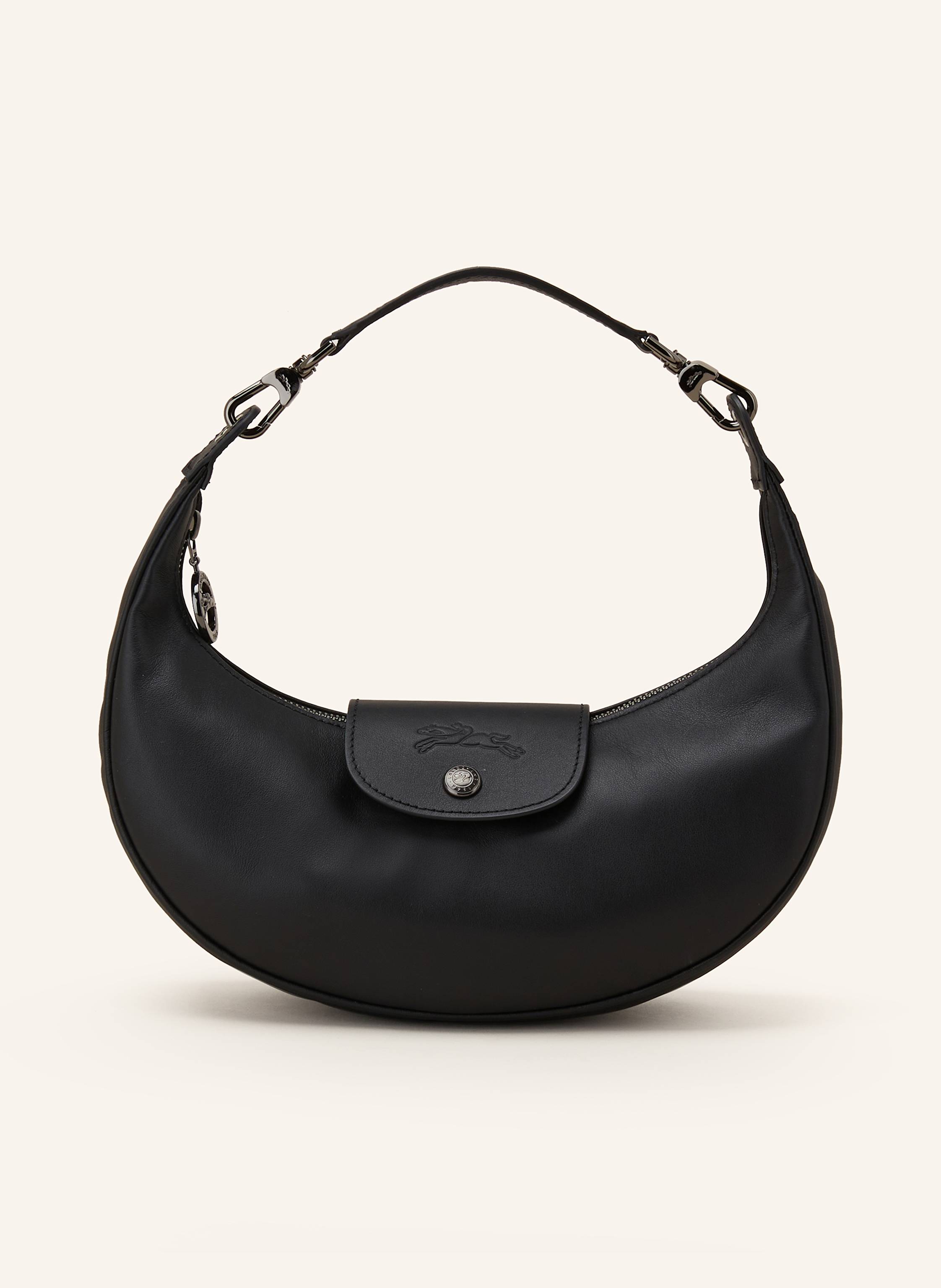 Longchamp Glattleder. Schließt mit Reißverschluss und Druckknopf. Ein Tragegriff. Innen ein Hauptfach. Innenfach mit Reißverschluss. Label-Prägung auf dem Umschlag in schwarz