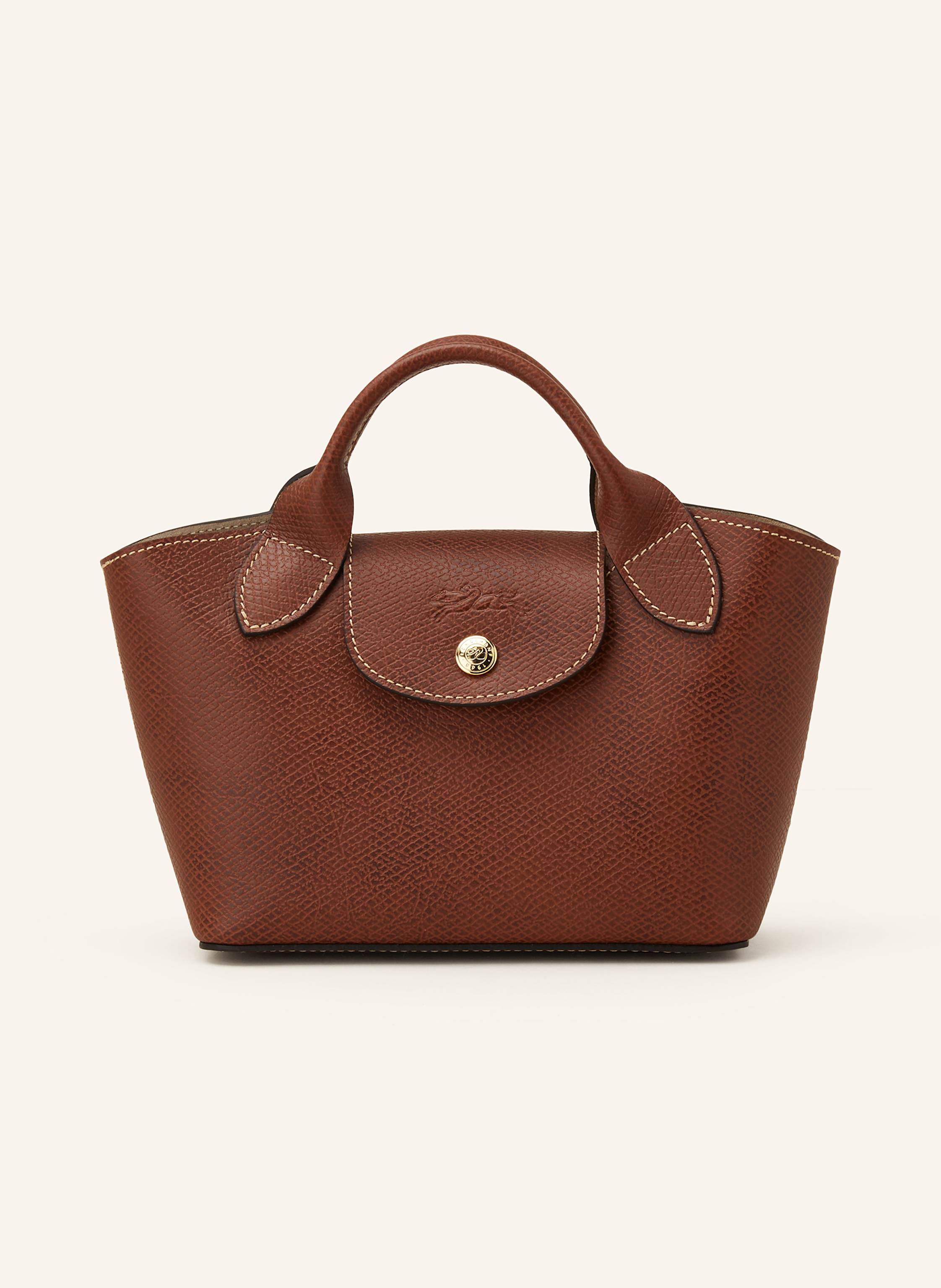 Longchamp Genarbtes Leder. Schließt mit Druckknopf. Zwei Tragegriffe. Abnehmbarer, längenverstellbarer Schulterriemen. Innen ein Hauptfach. Ein Steckfach. Verstärkter Taschenboden. Label-Prägung auf dem Übersch in braun
