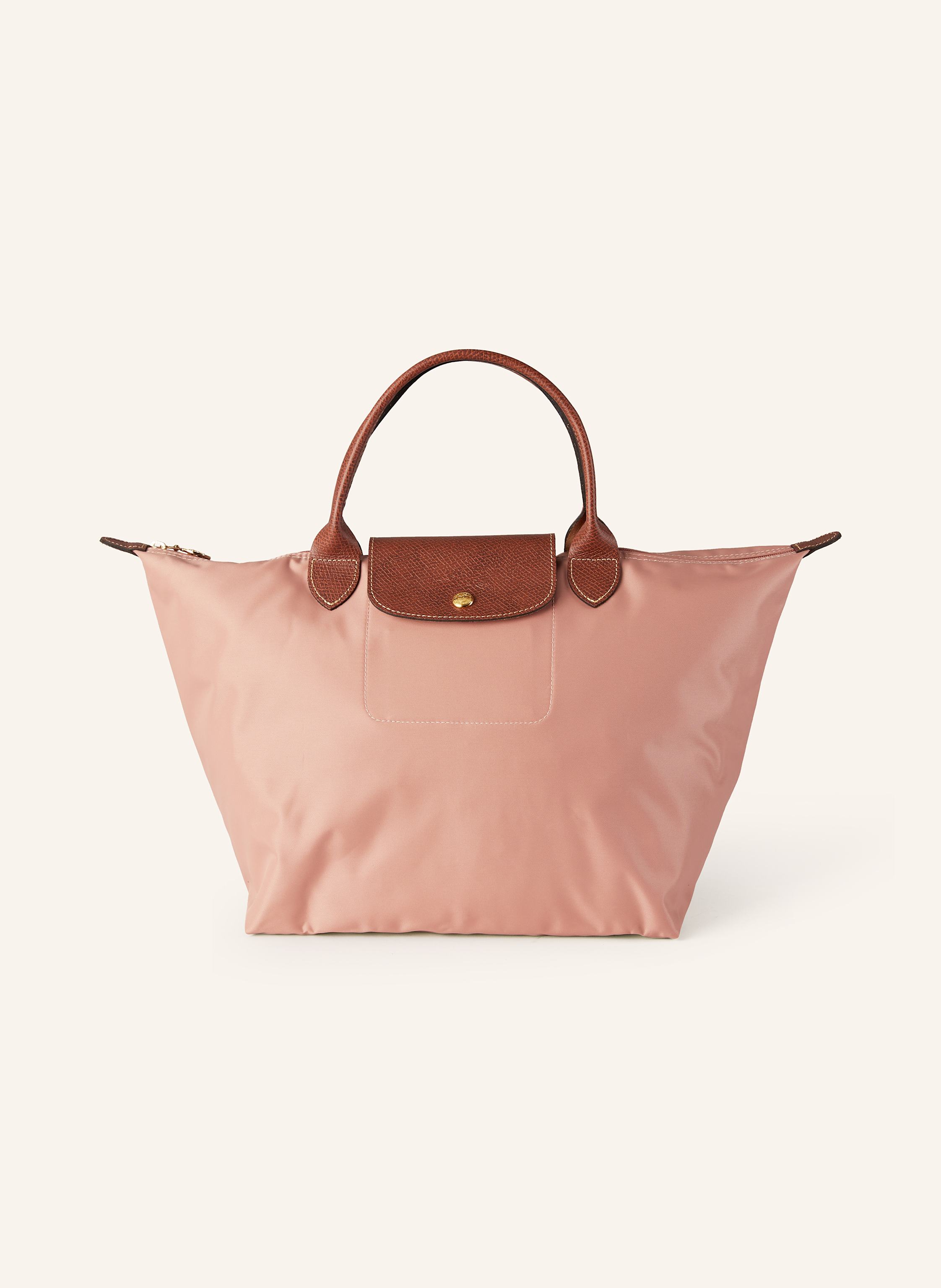 Longchamp Synthetik mit Lederdetails. Goldfarbene Metalldetails. Schließt mit einem Reißverschluss. Umschlag mit Druckknopf. Logo-Prägung. Faltbar in lachs