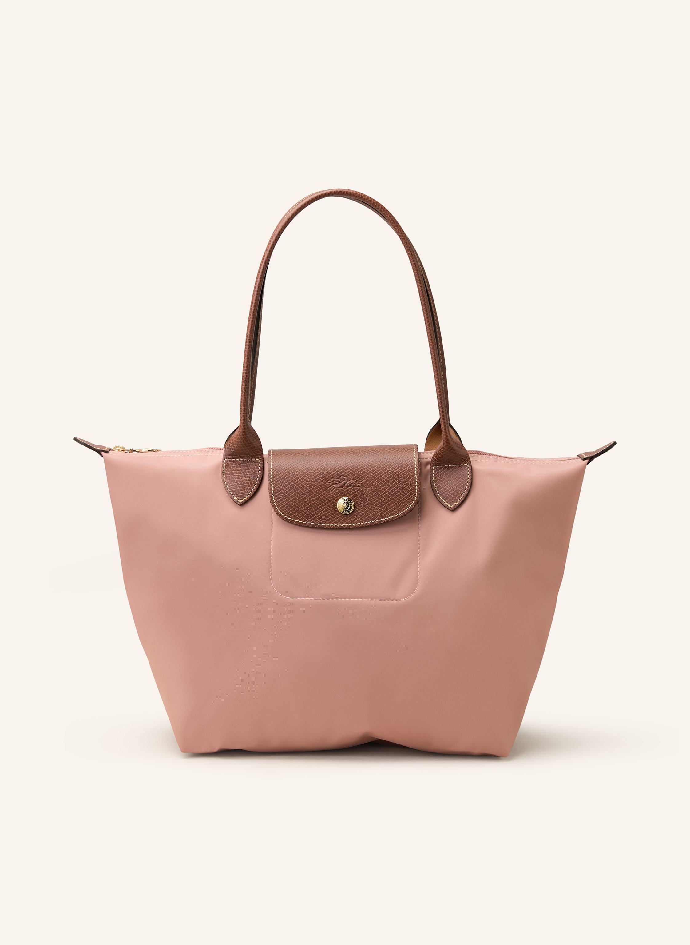 Longchamp Nylon und Leder. Tragehenkel. Schließt mit Reißverschluss. Lederbesatz mit Druckknopf und Logo-Prägung. Faltbar. Innentasche in nude