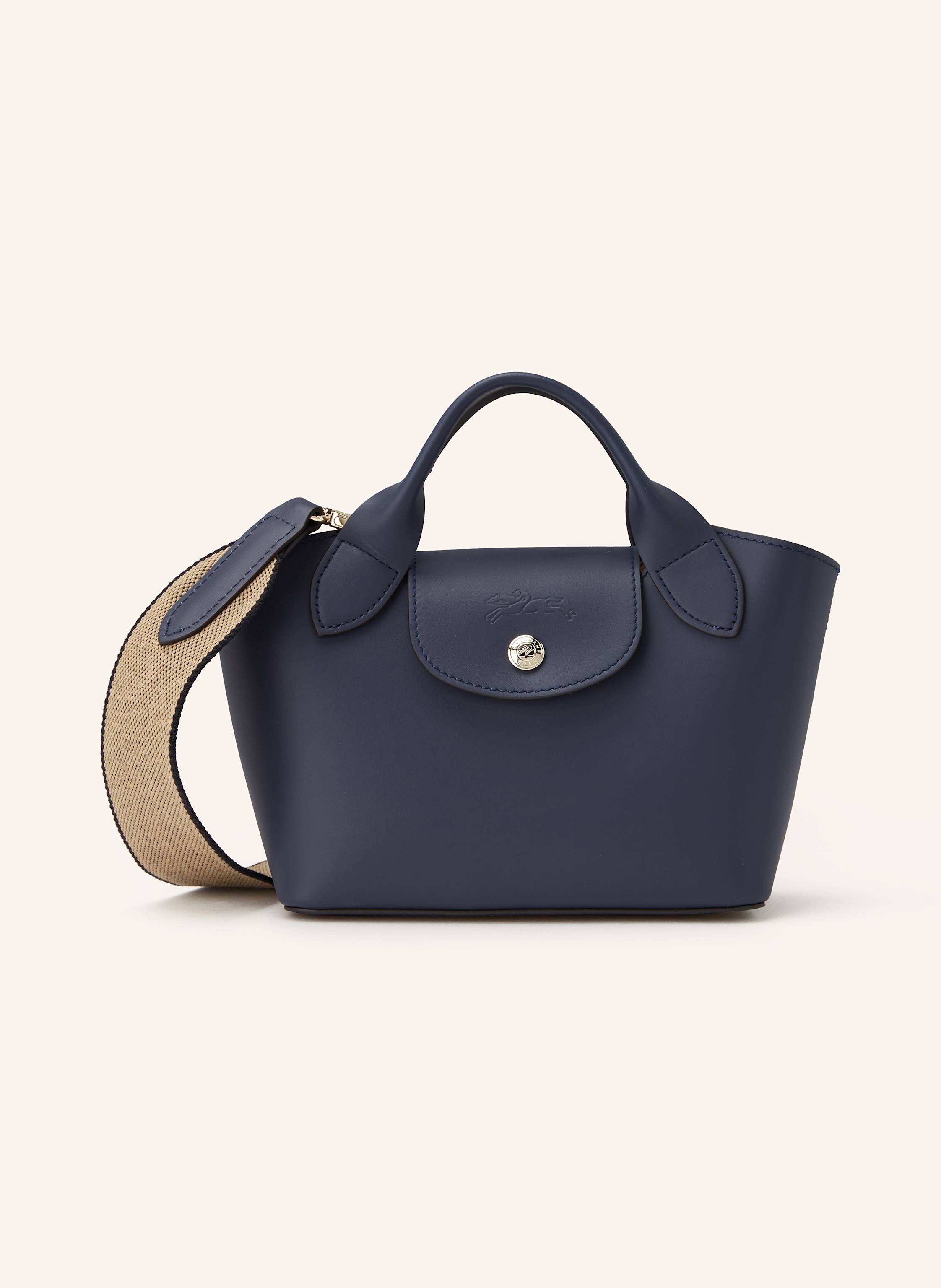 Longchamp Glattleder. Formstabile Silhouette. Schließt mit Druckknopfverschluss. Zwei Tragehenkel. Ein abnehmbarer, längenverstellbarer Schulterriemen. Innen ein Hauptfach. Ein Steckfach für Smartphone & Co. Ve in dunkelblau
