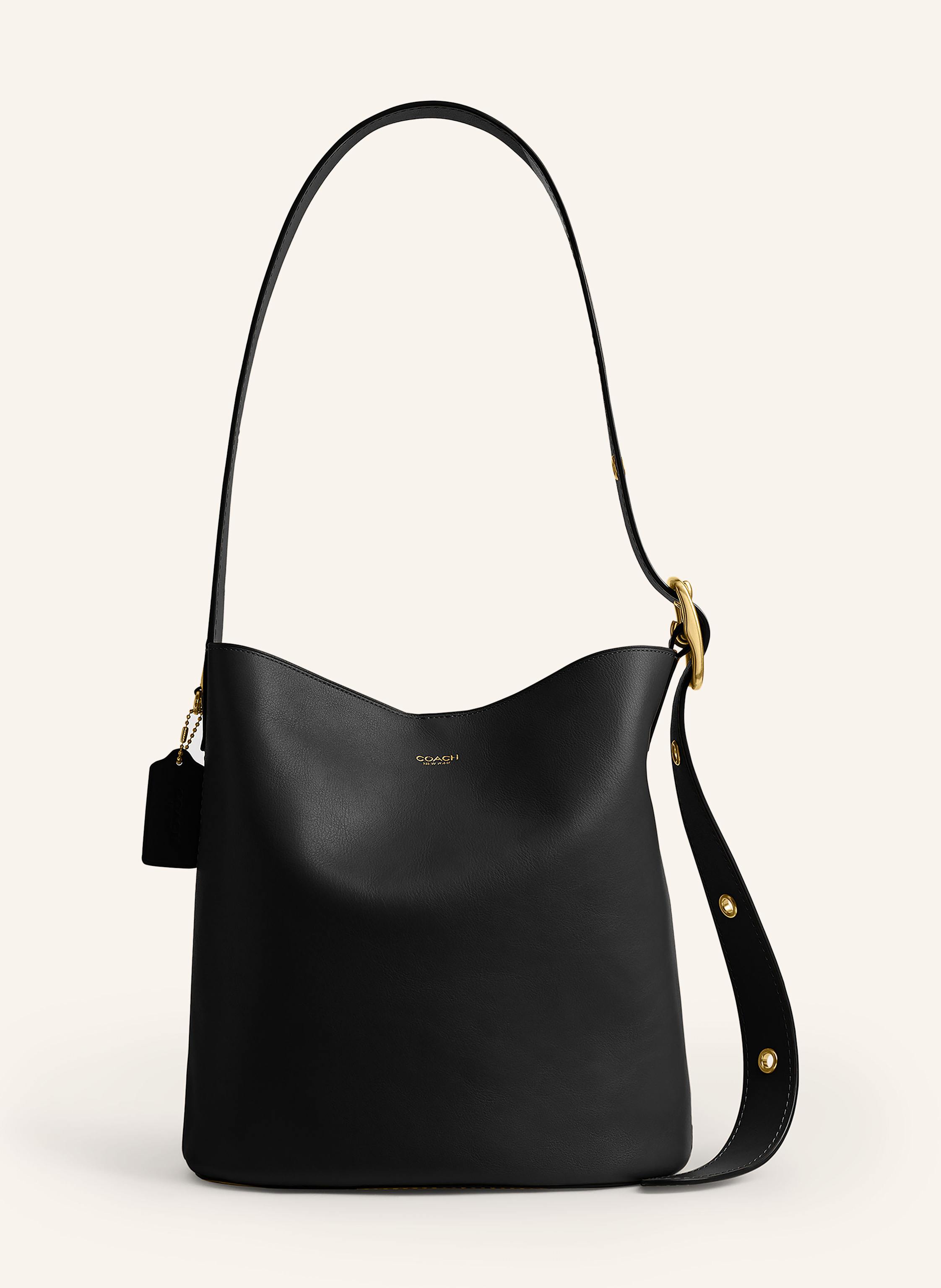 Coach Fein genarbtes Leder. Schließt mit magnetischem Druckknopf. Längenverstellbarer Schulterriemen. Innen zwei Hauptfächer. Ein Reißverschlussfach. Ein Steckfach innen. Verstärkter Taschenboden. Label-Pla in schwarz