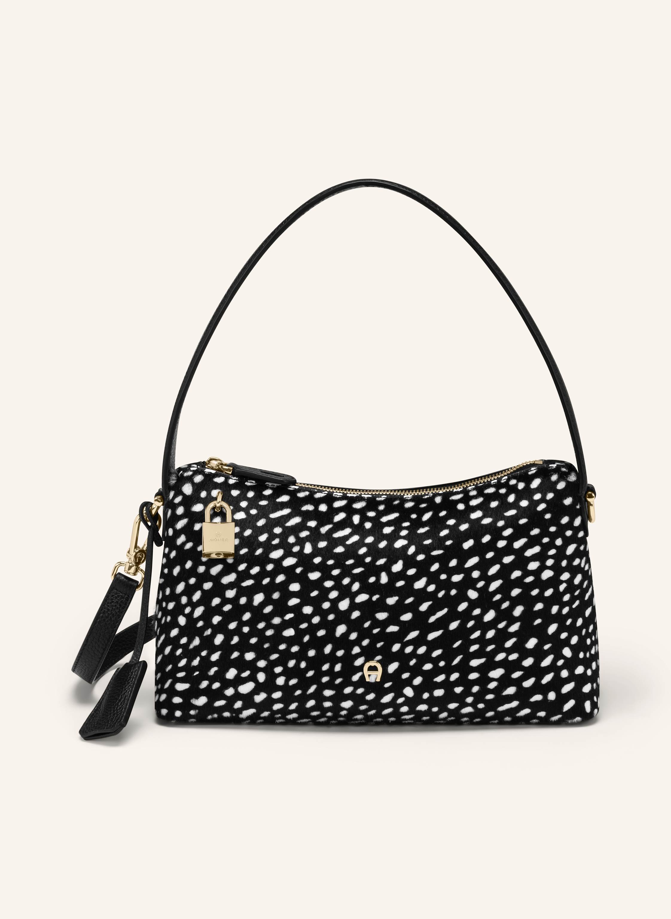 Aigner Die Puntina ist eine charmante Allround-Tasche, die sofort ins Auge fällt. Ihr sanftes Leder und die charakteristische AIGNER Ästhetik verleihen ihr eine warme, moderne Ausstrahlung. Ideal für alle, d in schwarz