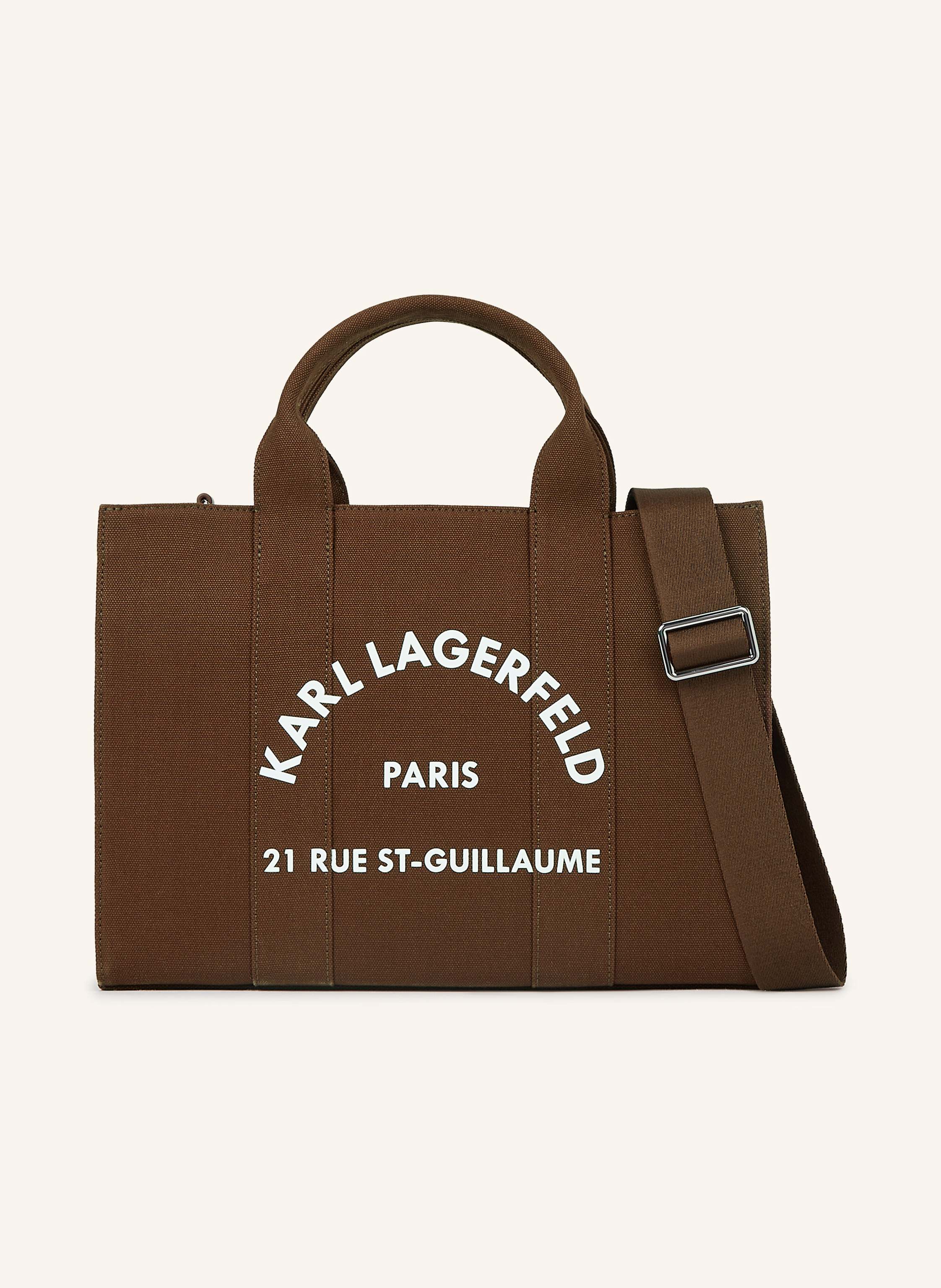 Karl Lagerfeld Ihre neue Lieblings-Tragetasche ist da. Nehmen Sie diese quadratische Tasche mit ins Büro, zum Brunch oder auf einen schicken Kurzurlaub übers Wochenende. Verstärkte, doppelte Tragegriffe. Abnehmbarer in braun