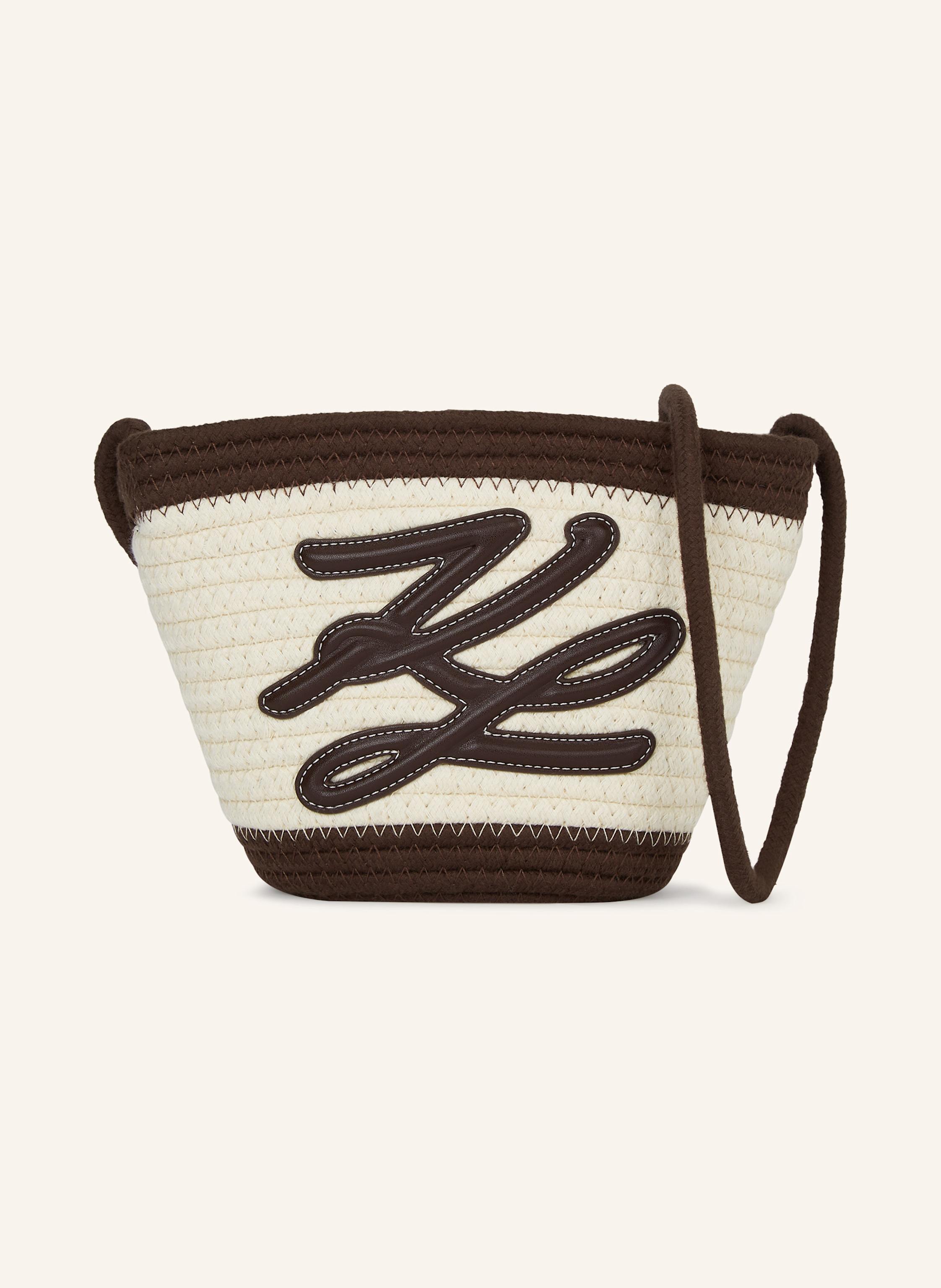 Karl Lagerfeld Eine zierliche Strandtasche aus Baumwollseilen mit kontrastierenden Rändern. Der elegante Crossbody-Riemen und das Autograph-Logo aus technischem Leder verleihen diesem strandtauglichen Accessoire ein in dunkelbraun