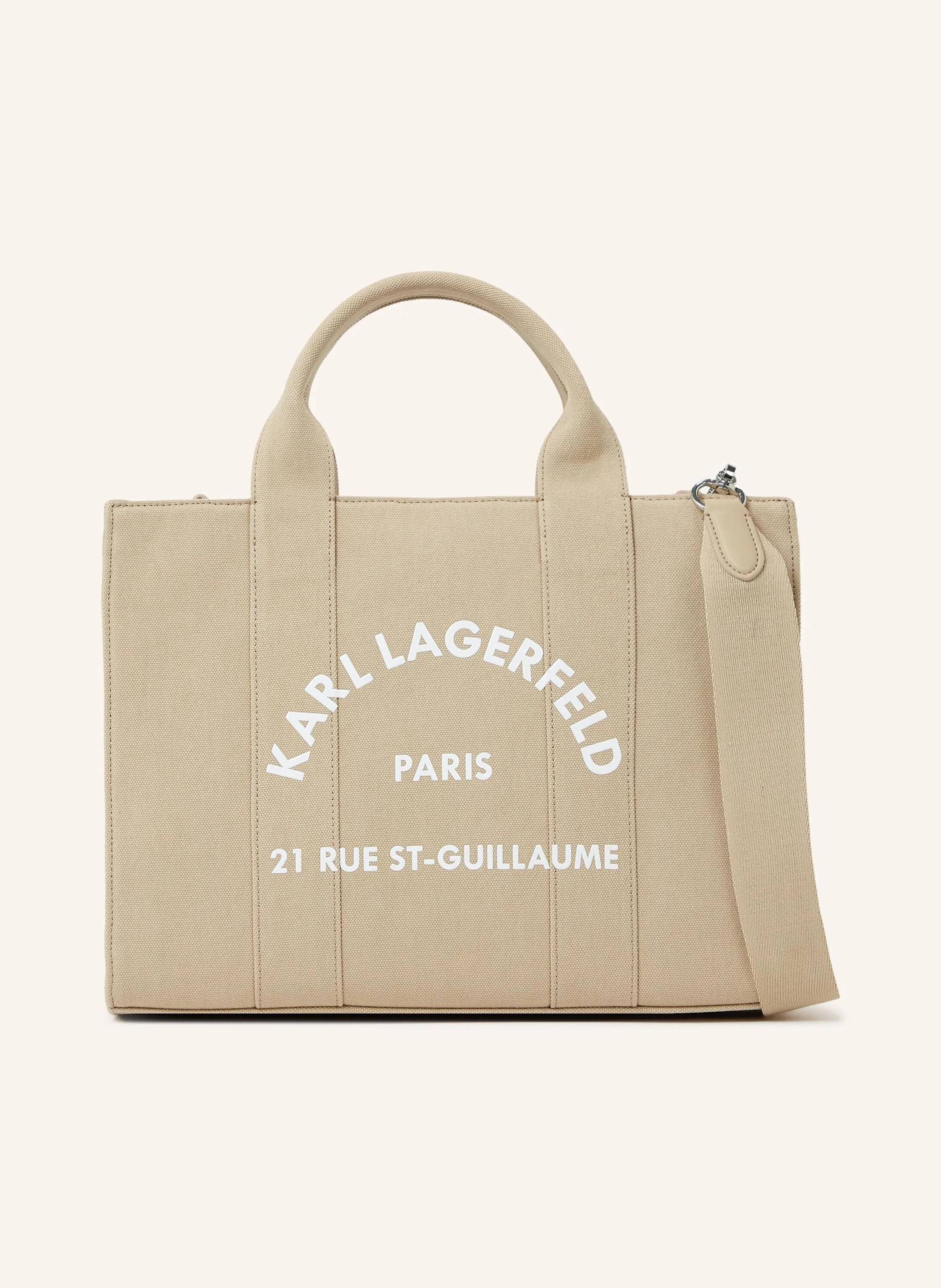 Karl Lagerfeld Ihre neue Lieblings-Tragetasche ist da. Nehmen Sie diese quadratische Tasche mit ins Büro, zum Brunch oder auf einen schicken Kurzurlaub übers Wochenende. Verstärkte, doppelte Tragegriffe. Abnehmbarer in beige