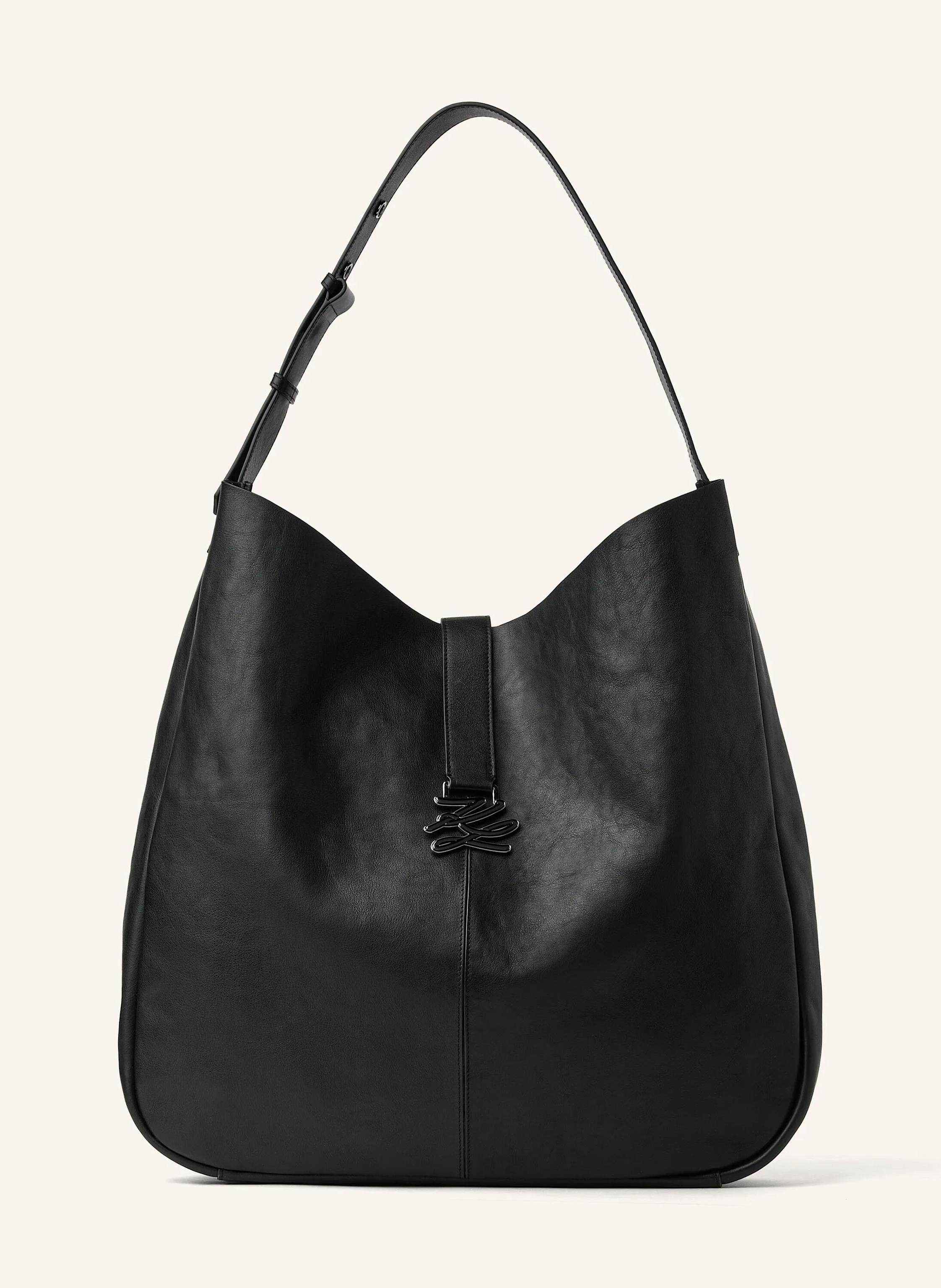 Karl Lagerfeld This oversized hobo bag blends a spacious slouchy silhouette with supple cow leather for effortless luxury. The adjustable shoulder strap ensures comfort, while the metal Karl Autograph logo adds a re in schwarz