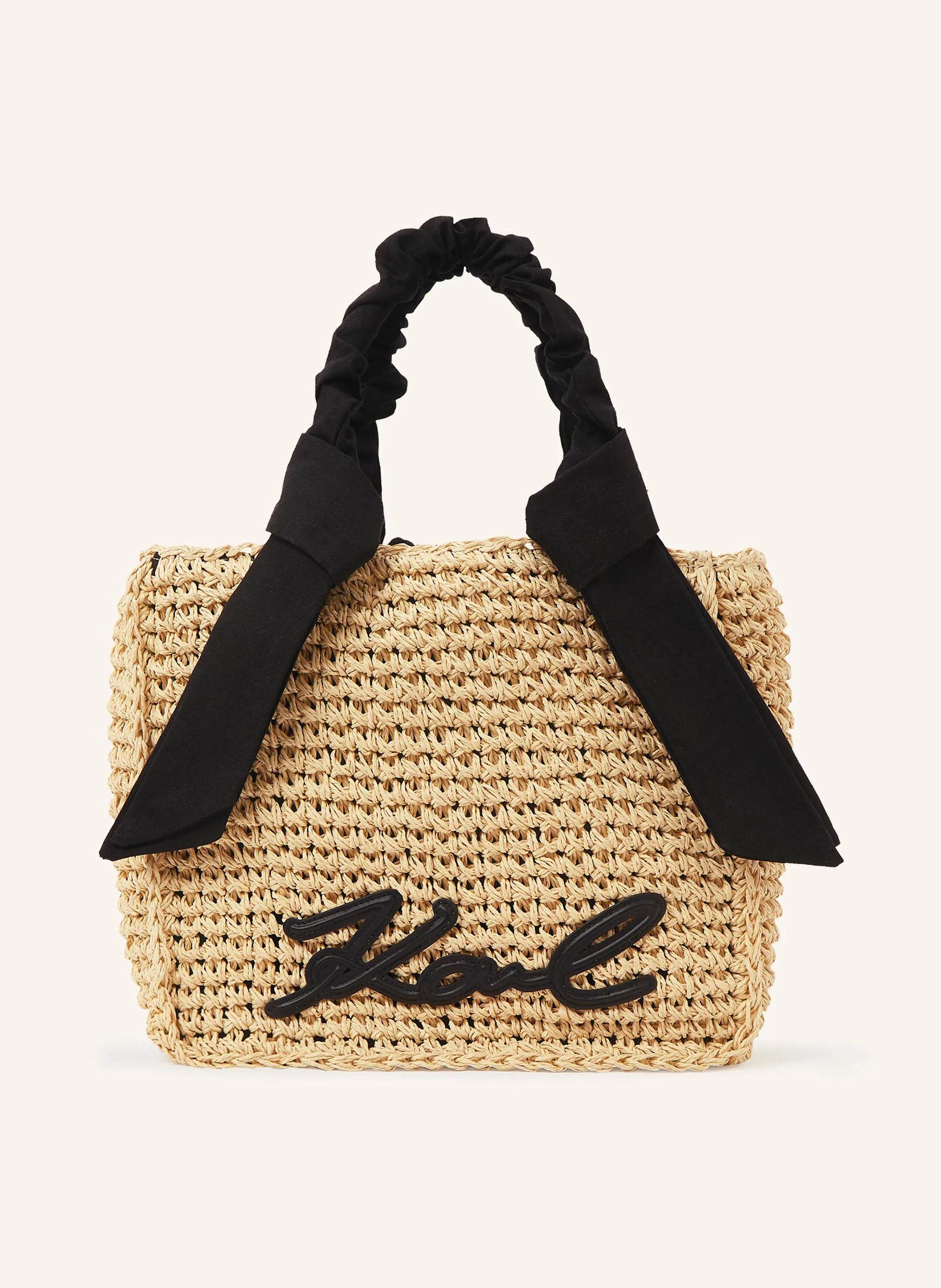 Karl Lagerfeld Sonnige Eleganz prägt diese gewebte Strandtasche, bei der strukturierte Griffe und abnehmbare Schals mühelose Stylingwechsel erlauben. Schöne Webkonstruktion und quadratische Silhouette. Strukturierte in beige