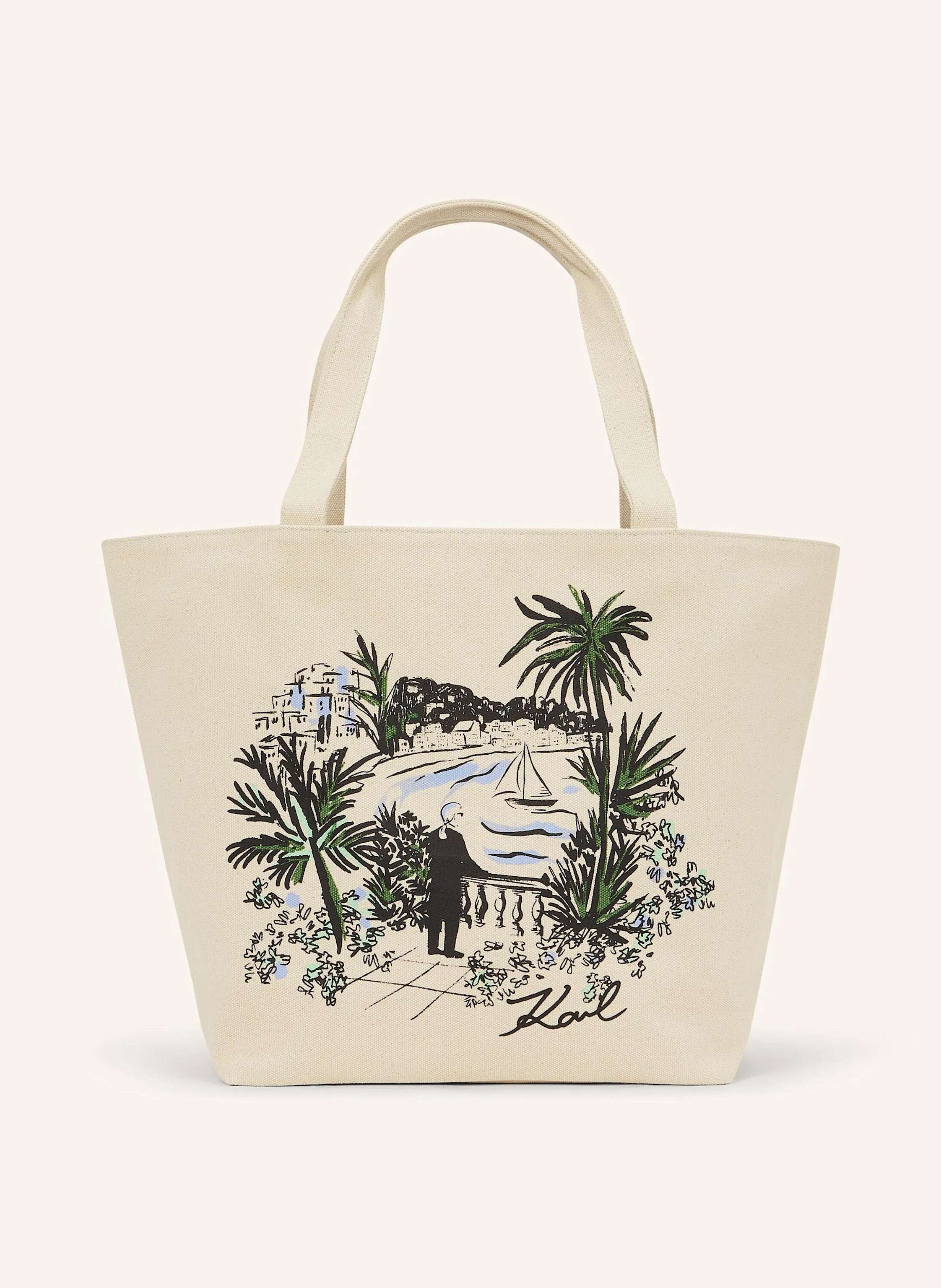 Karl Lagerfeld Soft recycled cotton shapes this reversible shopper, offering a playful contrast with artful prints on each side. Twin handles make it effortless to carry anywhere. Fully reversible silhouette. Twin t in beige/ schwarz