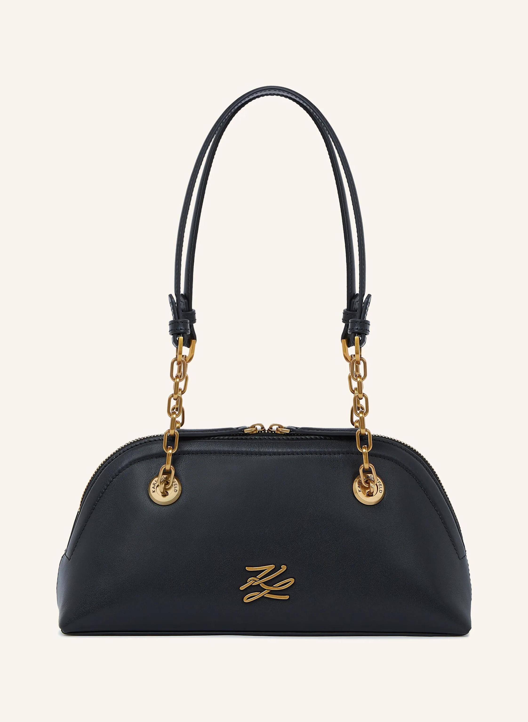 Karl Lagerfeld This small bowling bag redefines contemporary style with its smooth leather and chic chain straps. The embossed Karl Autograph logo adds an elegant touch, while the zip-top keeps essentials secure. Co in schwarz/ gold