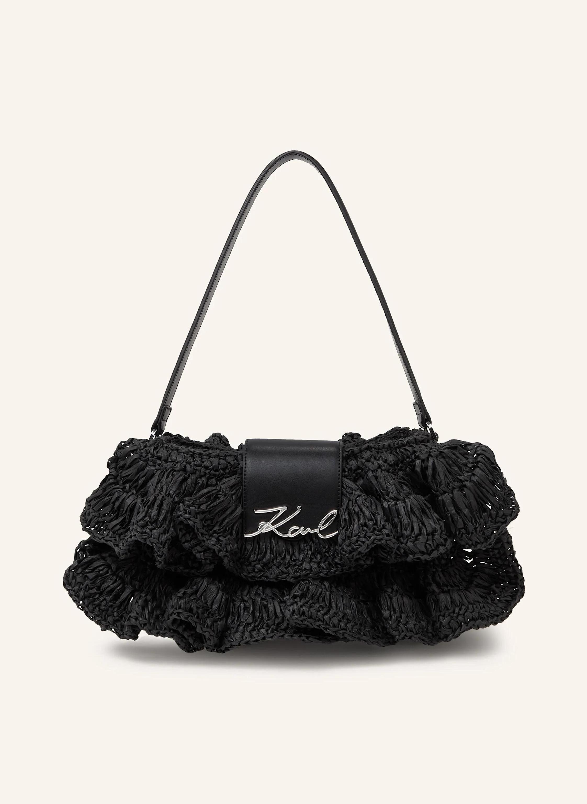 Karl Lagerfeld The ruffle shoulder bag offers a playful woven design paired with a comfortable leather strap. Its zip-top closure keeps essentials secure, blending elegance with everyday ease. Zip-top closure with l in schwarz