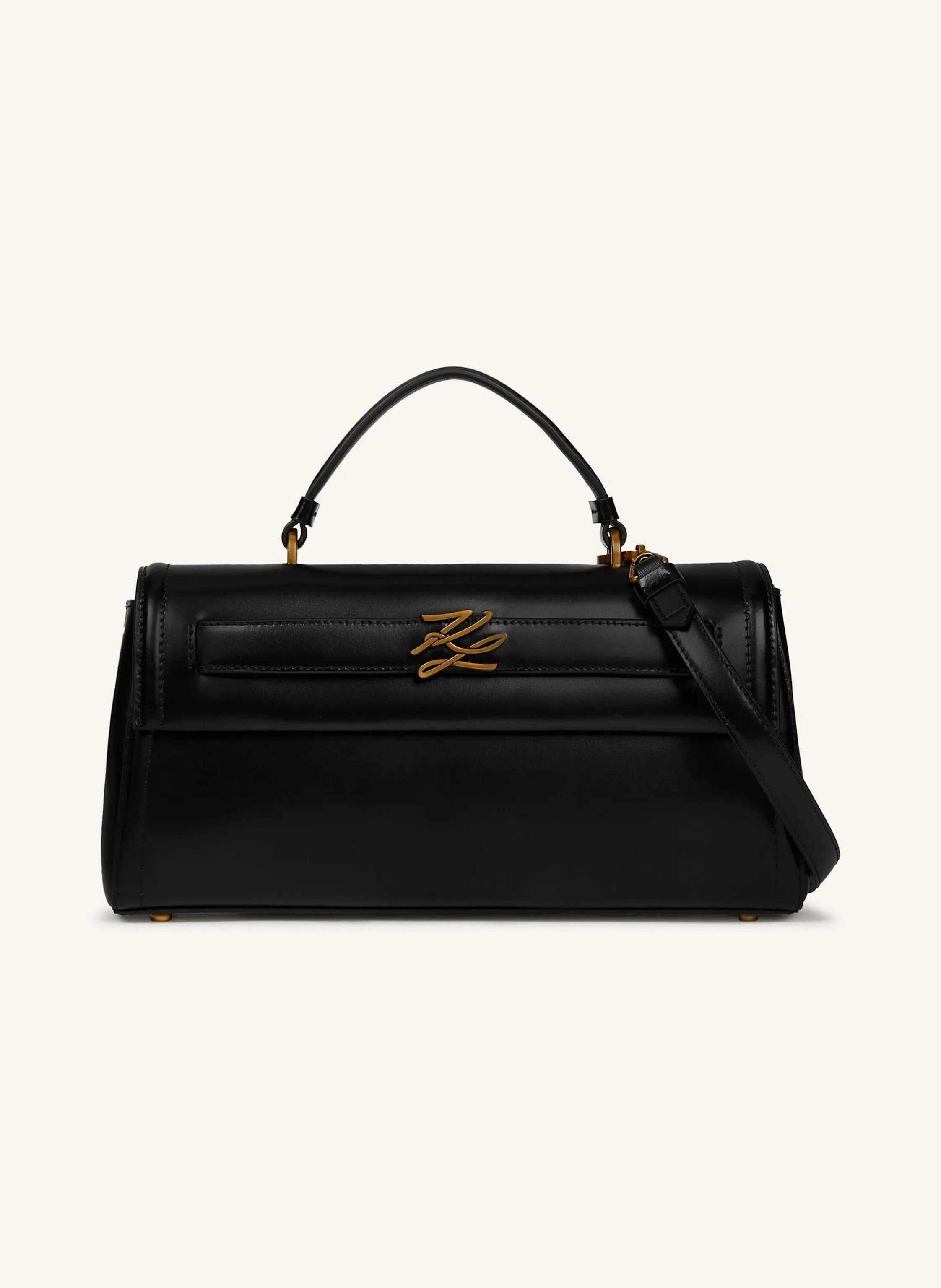 Karl Lagerfeld Schmal und raffiniert: Diese längliche Ledertasche verfügt über einen eleganten Klappverschluss und einen vielseitigen Trageriemen für müheloses Styling für Tag und Nacht. Das charakteristische Karl-A in schwarz/ gold