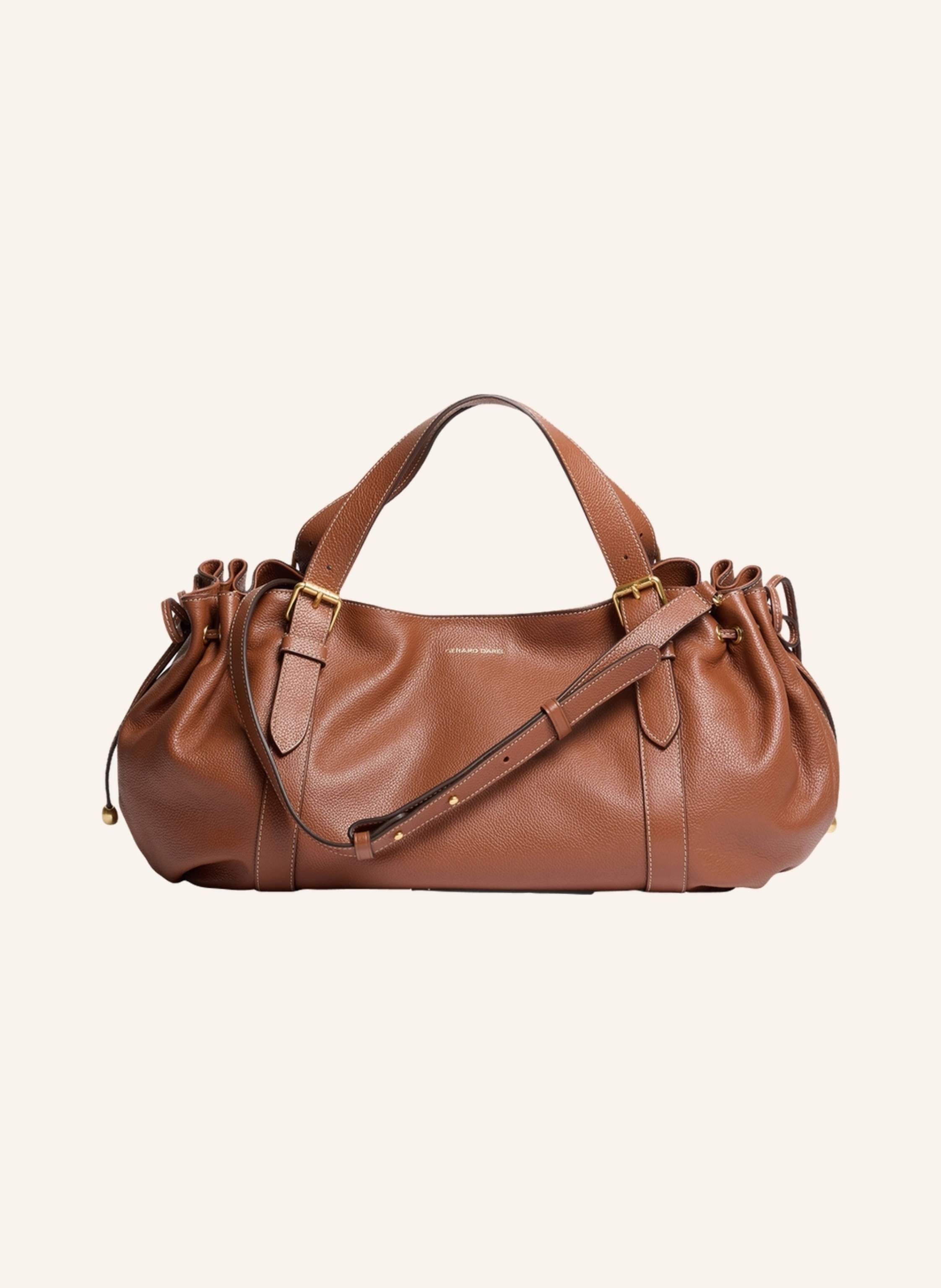 Gerard Darel Die 24 H Premium ist eine zarte Variation des ikonischen Modells des Hauses und verspricht eine harmonische Verbindung von Eleganz und Funktionalität.Sein genarbtes Leder in Sattlerfarben, das für den in braun