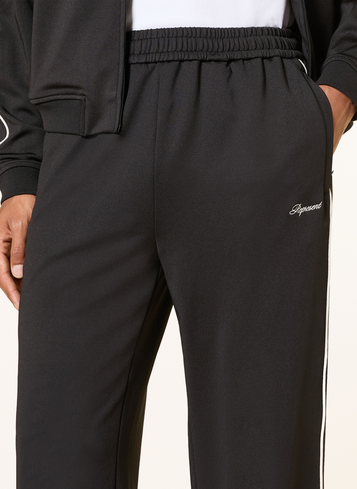 REPRESENT Track pants with braided stripes: BLACK / WHITE