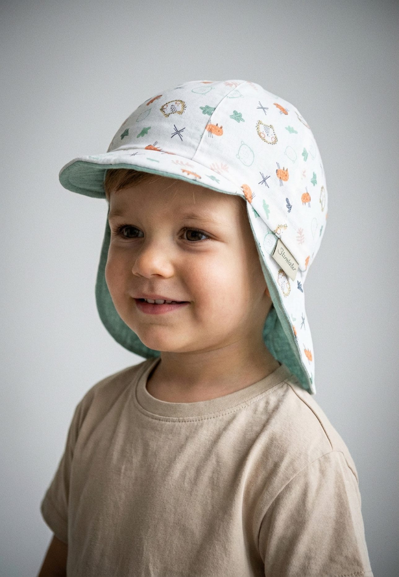 Sterntaler Wende-Schirmmütze Tiere: TÜRKIS