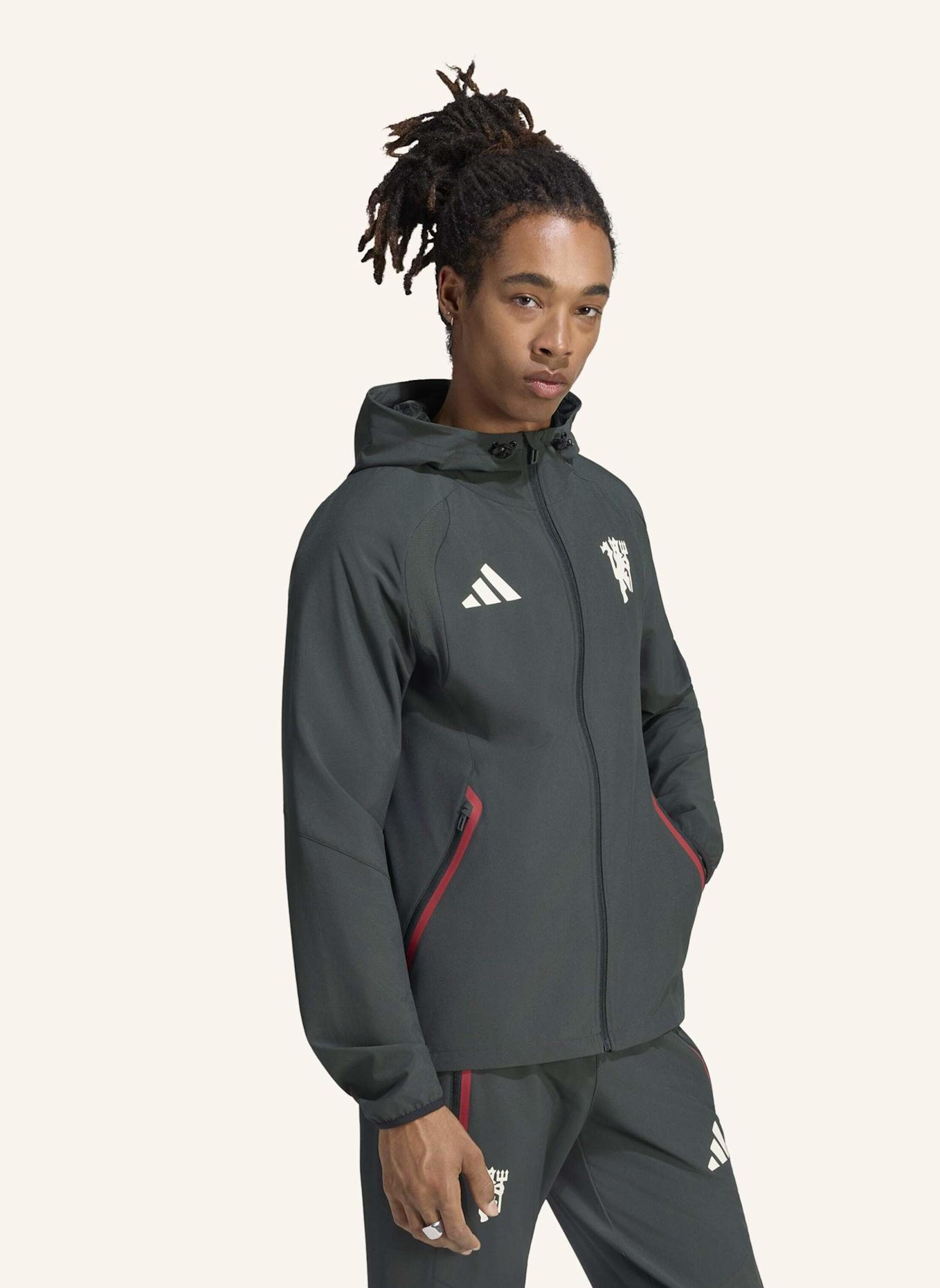 adidas MACHCHESTER UNITED TIRO TRAVEL WINDBREAKER, DURCHGEHENDER REISSVERSCHLUSS: GRÜN